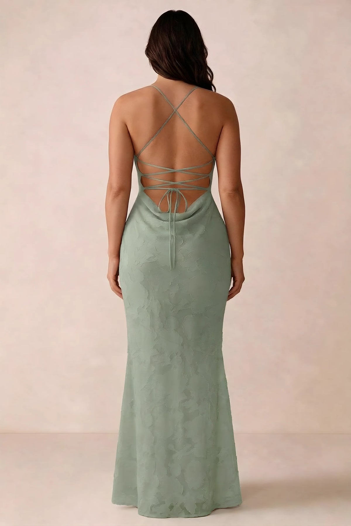 Back studio view of Bess light green dress showing the crossed straps and full-length silhouette