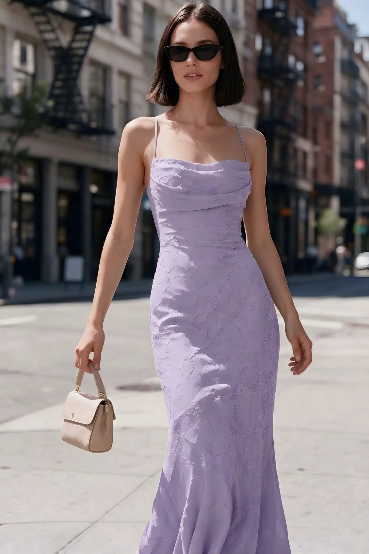 Outdoor front view of Bess lilac floral burnout dress styled with sunglasses on a city street