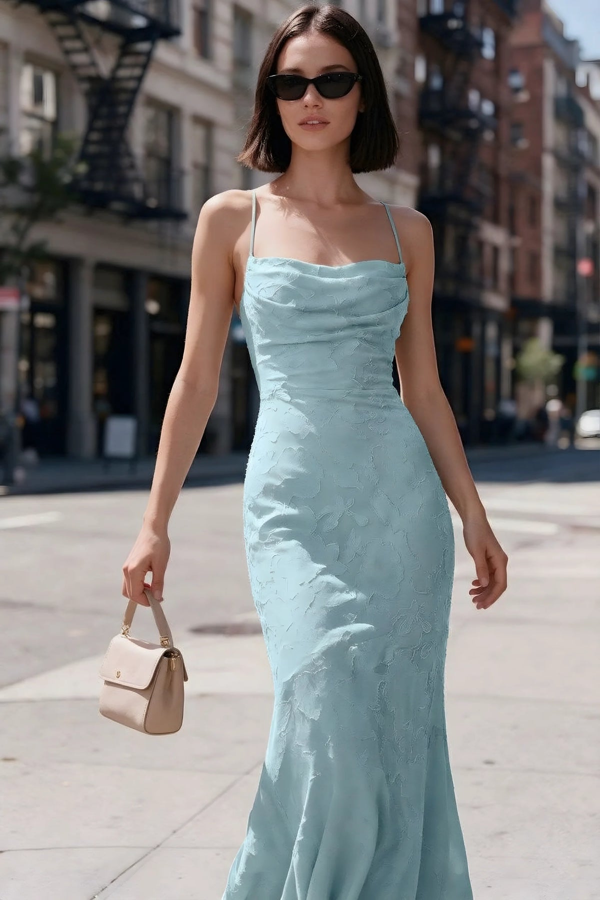 Outdoor front view of Bess mist floral burnout dress styled with sunglasses on a city street