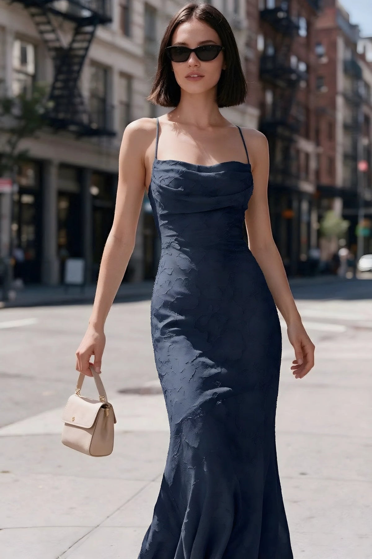 Outdoor front view of Bess navy floral burnout dress styled with sunglasses on a city street