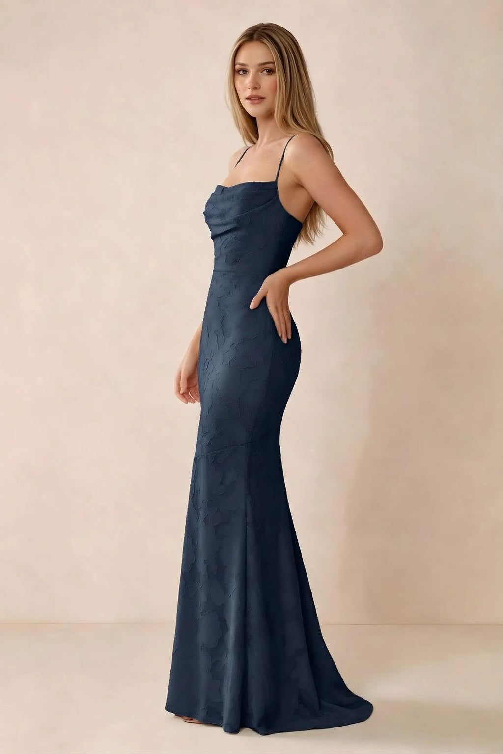 Three-quarter studio view of Bess navy dress showing the close-fitting waist and gently flared hem