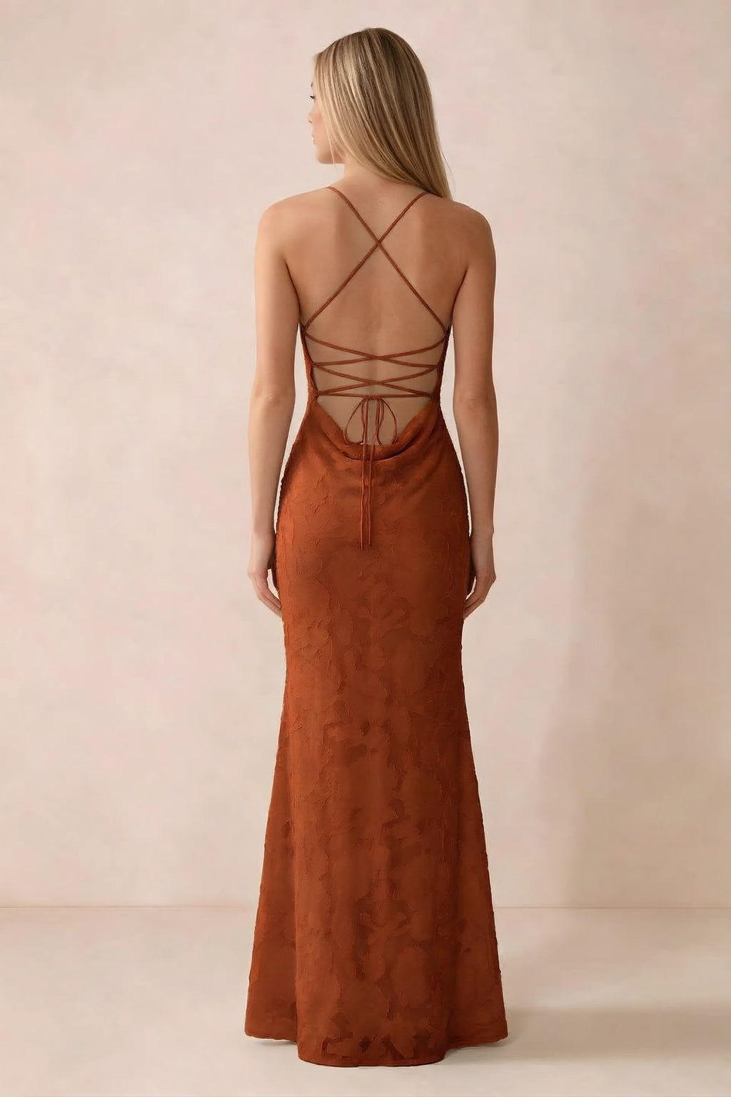 Rear studio view of Bess paprika dress showing cross-back lacing above a low cowl drape