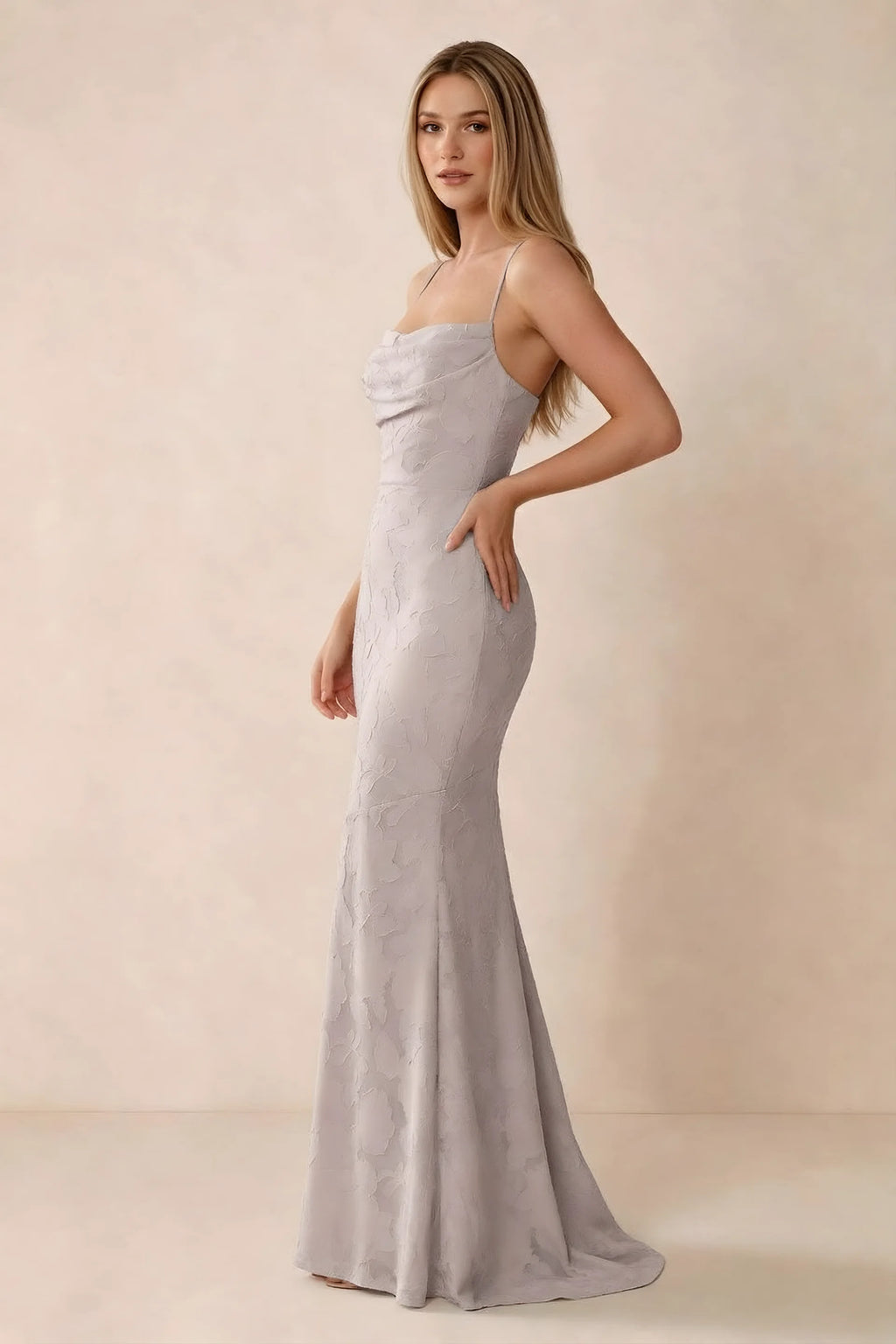 Three-quarter studio view of Bess powder pink dress showing the close-fitting waist and gently flared hem