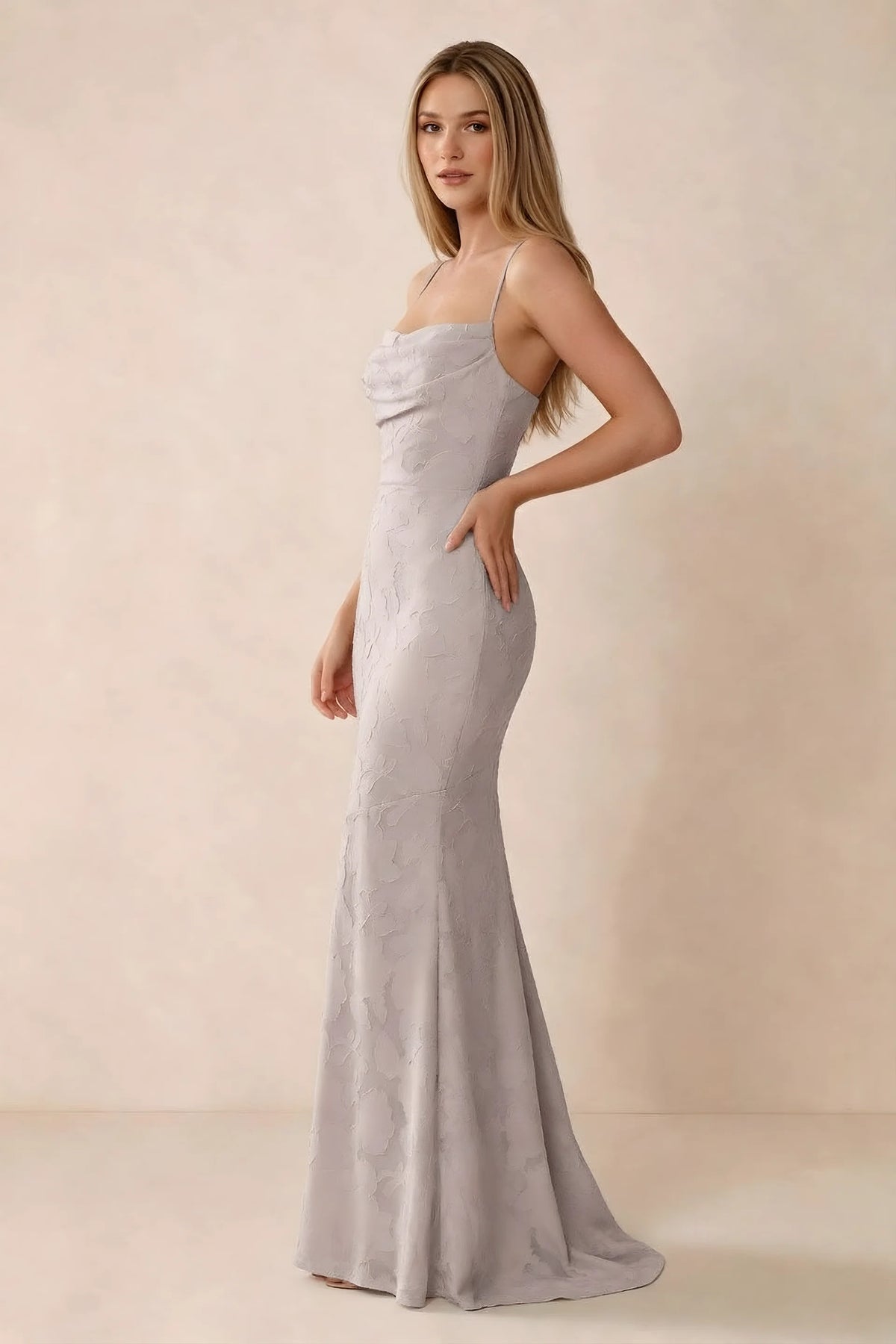 Three-quarter studio view of Bess powder pink dress showing the close-fitting waist and gently flared hem