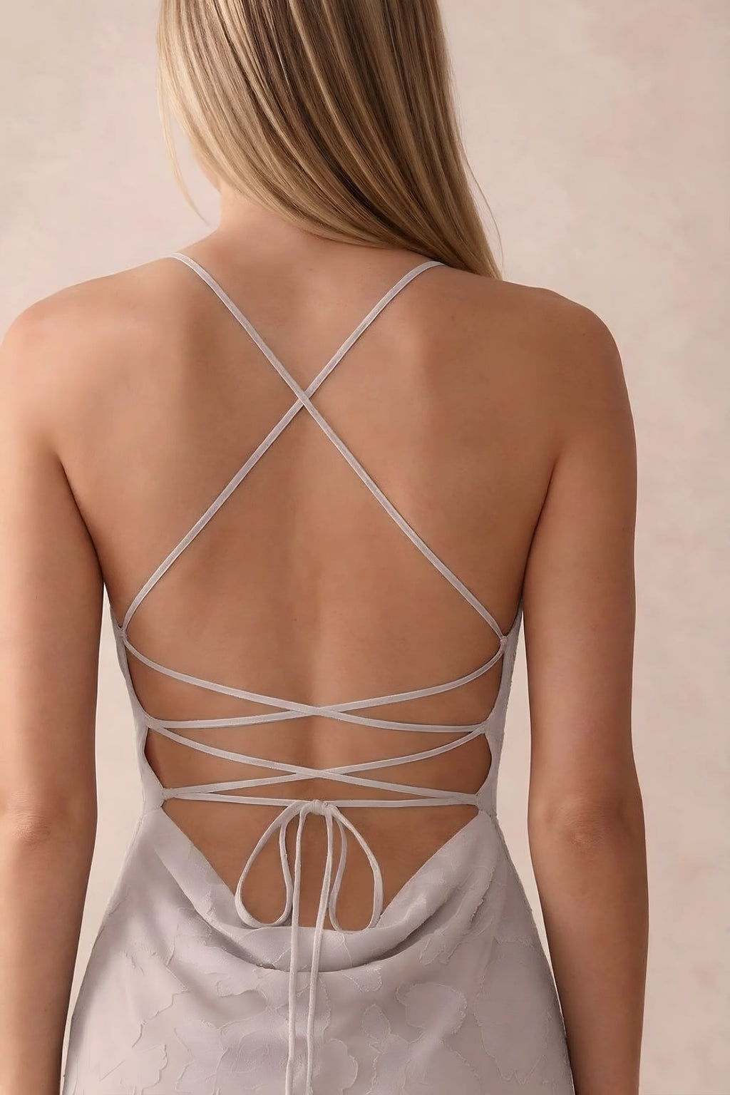 Close-up of Bess powder pink open back with crossed straps, tie fastening and low cowl drape