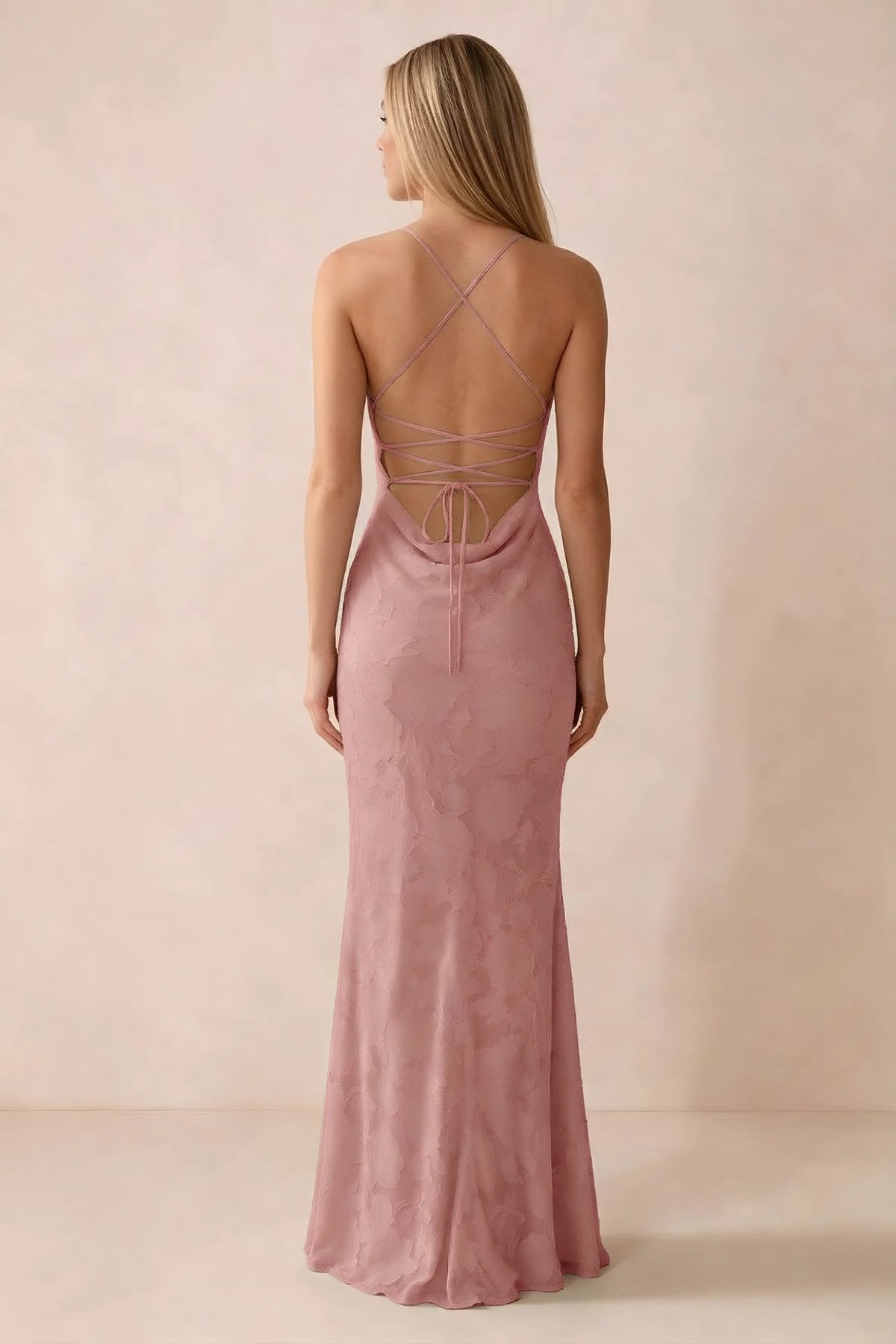 Rear studio view of Bess rosette dress showing cross-back lacing above a low cowl drape