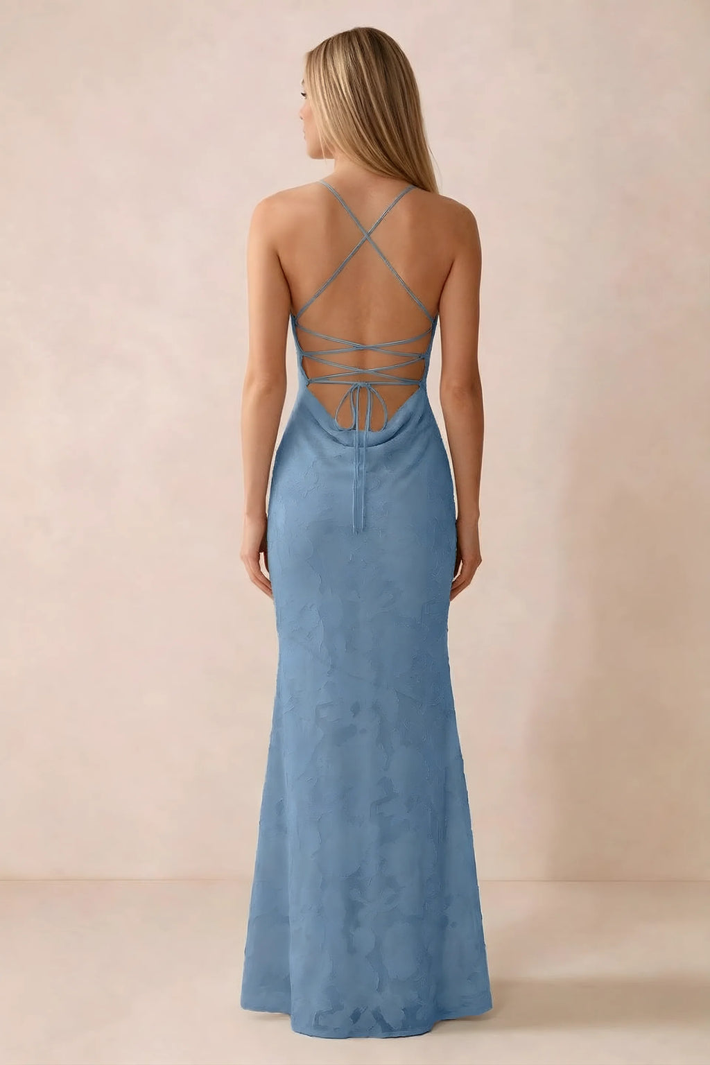Rear studio view of Bess steel blue dress showing cross-back lacing above a low cowl drape