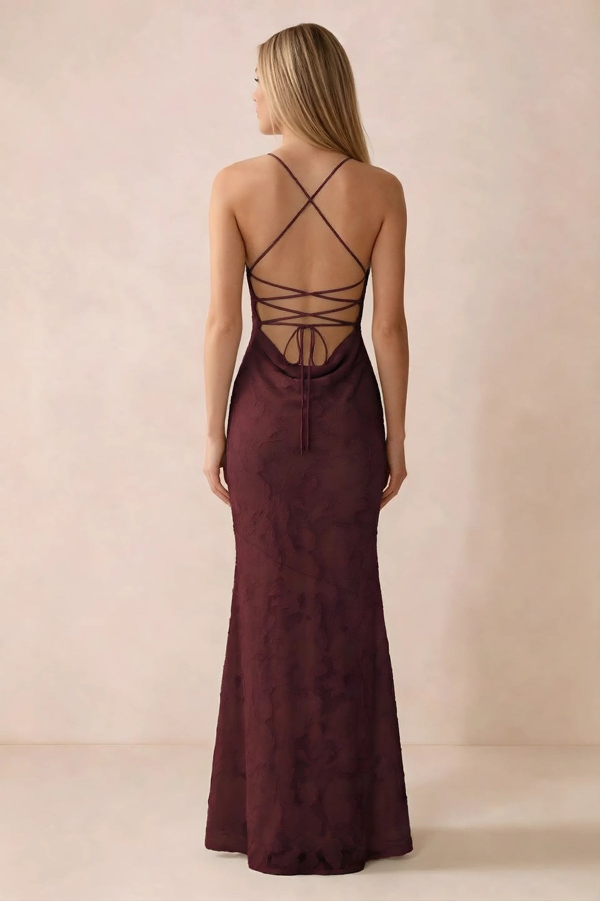 Rear studio view of Bess wine dress showing cross-back lacing above a low cowl drape
