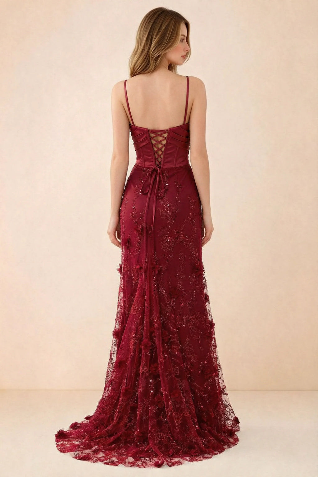 Rear studio view of Beth burgundy dress showing corset back lacing and a trailing floral hem