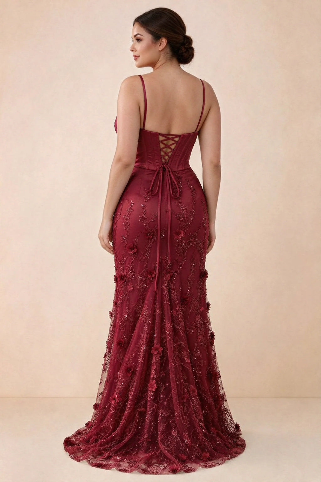 Rear studio view of Beth burgundy corset dress with fine straps, back ties and a trailing hem