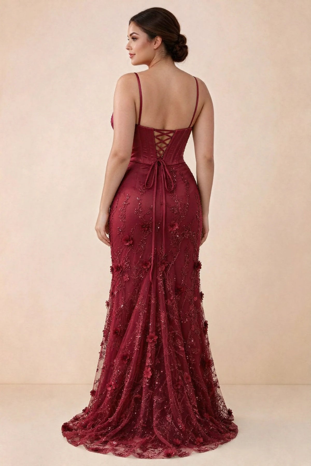 Rear studio view of Beth burgundy corset dress with fine straps, back ties and a trailing hem