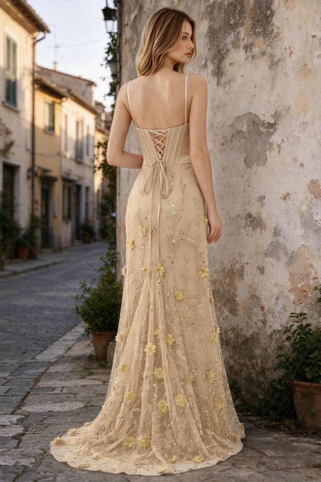 Outdoor rear view of Beth champagne maxi dress showing back lacing and the long embellished skirt