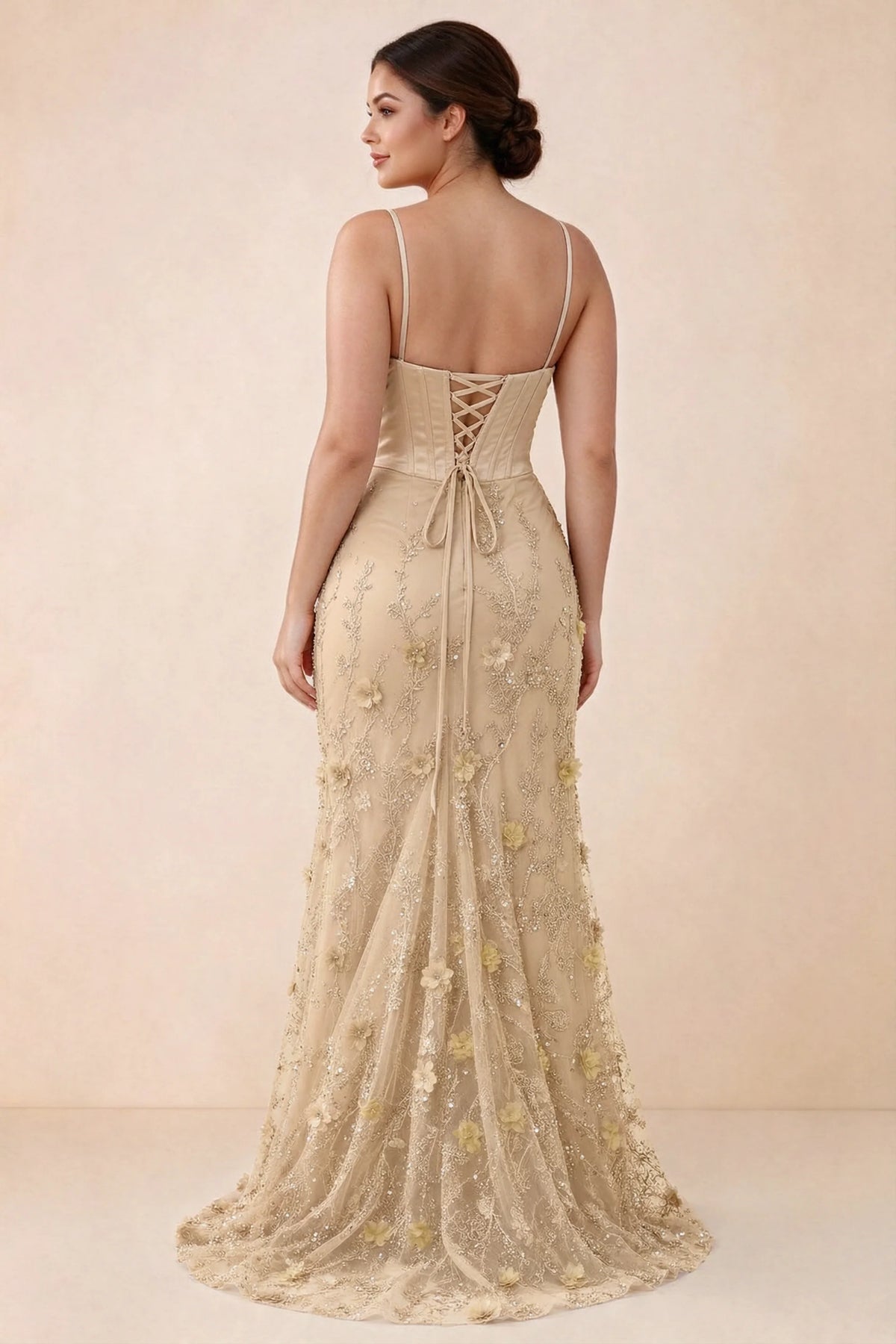 Rear studio view of Beth champagne corset dress with fine straps, back ties and a trailing hem