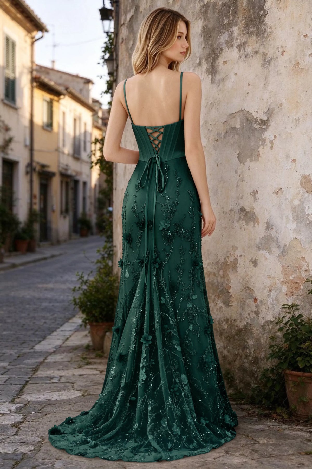 Outdoor rear view of Beth dark green maxi dress showing back lacing and the long embellished skirt