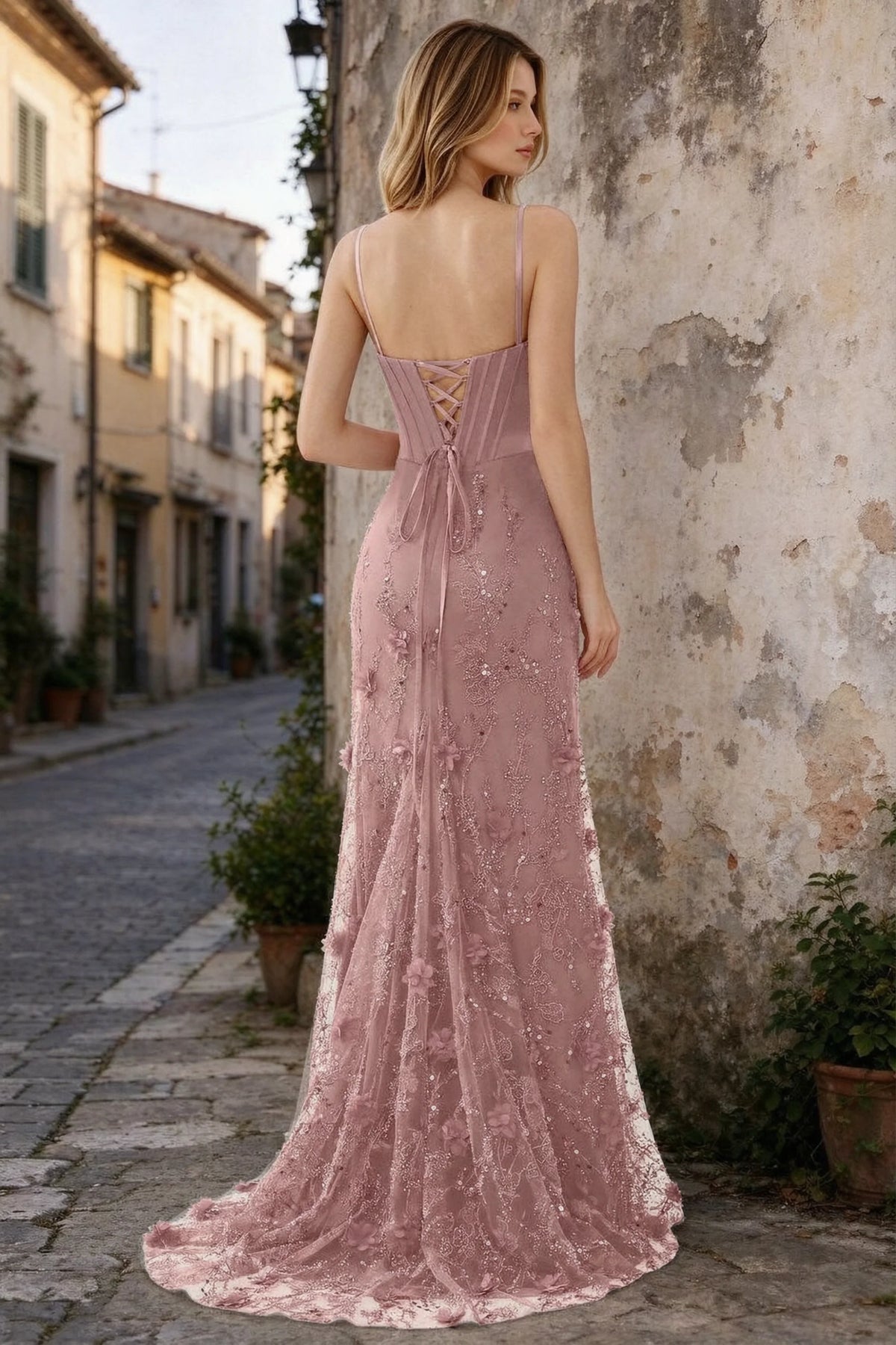 Outdoor rear view of Beth pink maxi dress showing back lacing and the long embellished skirt