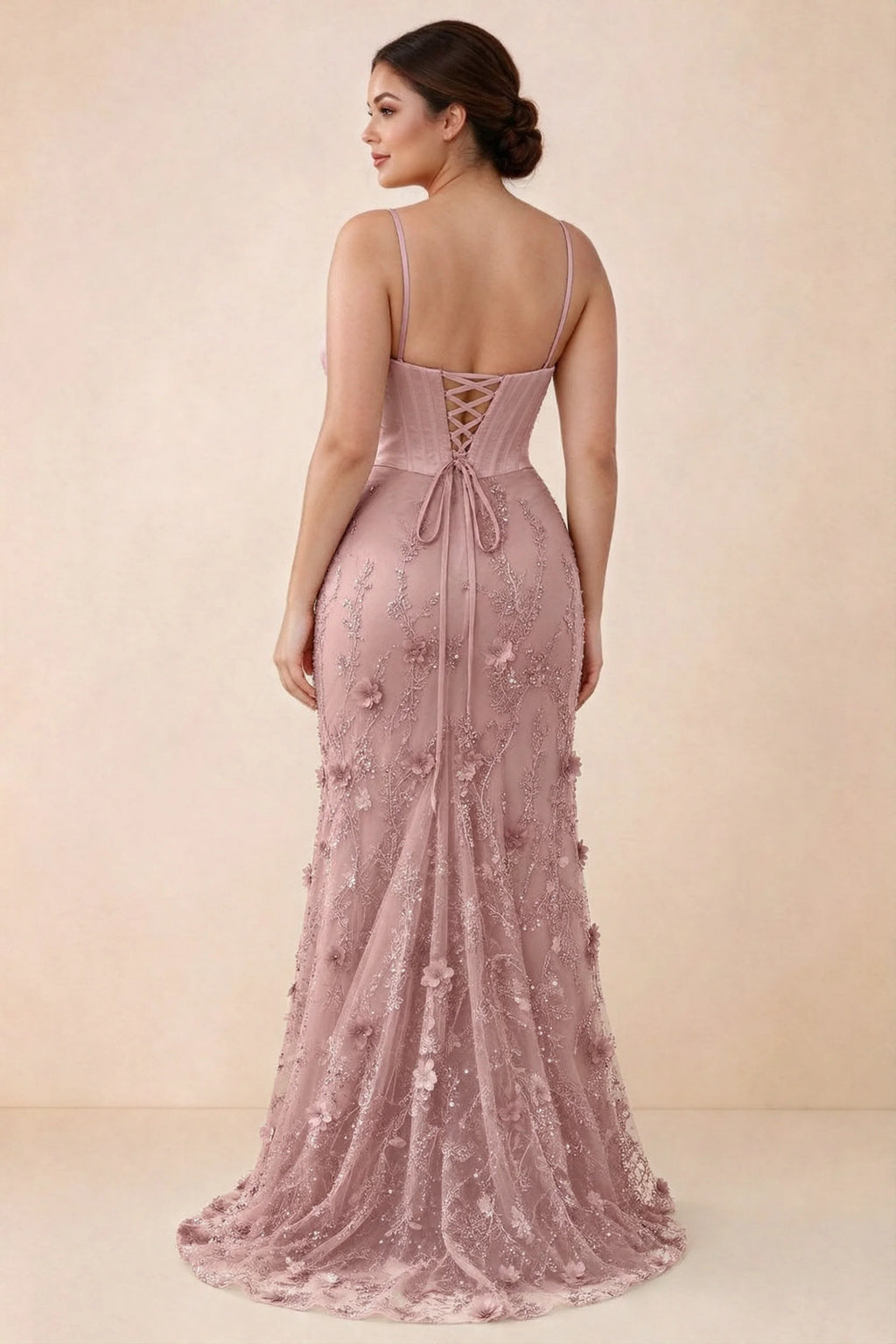 Rear studio view of Beth pink corset dress with fine straps, back ties and a trailing hem