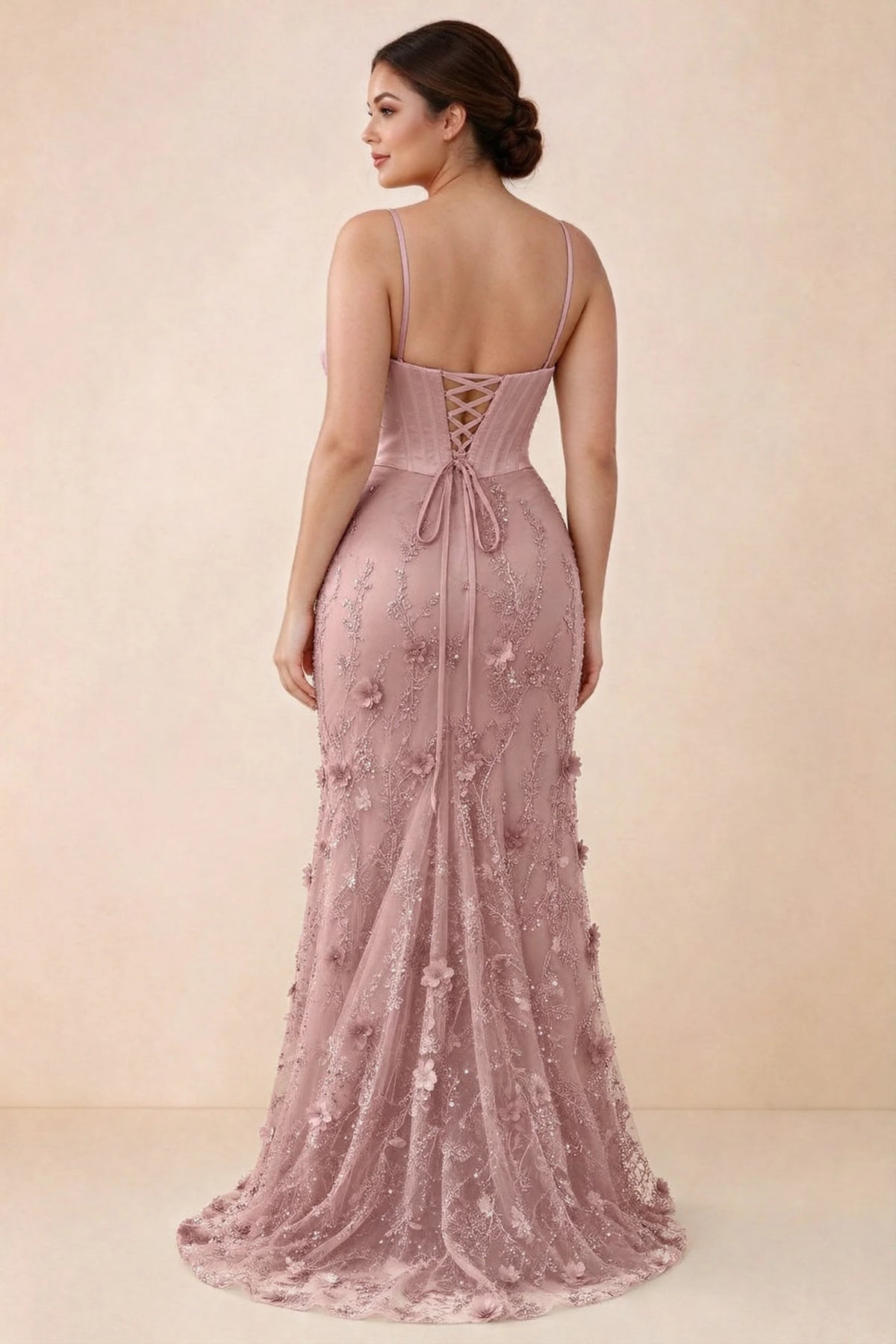 Rear studio view of Beth pink corset dress with fine straps, back ties and a trailing hem
