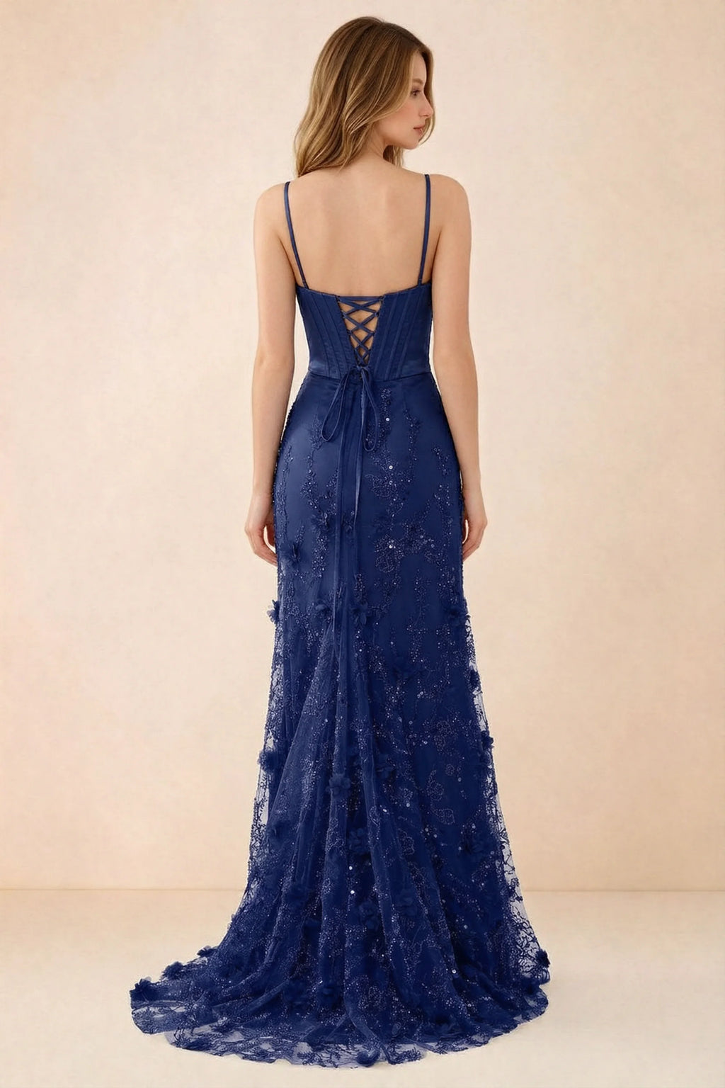 Rear studio view of Beth navy dress showing corset back lacing and a trailing floral hem