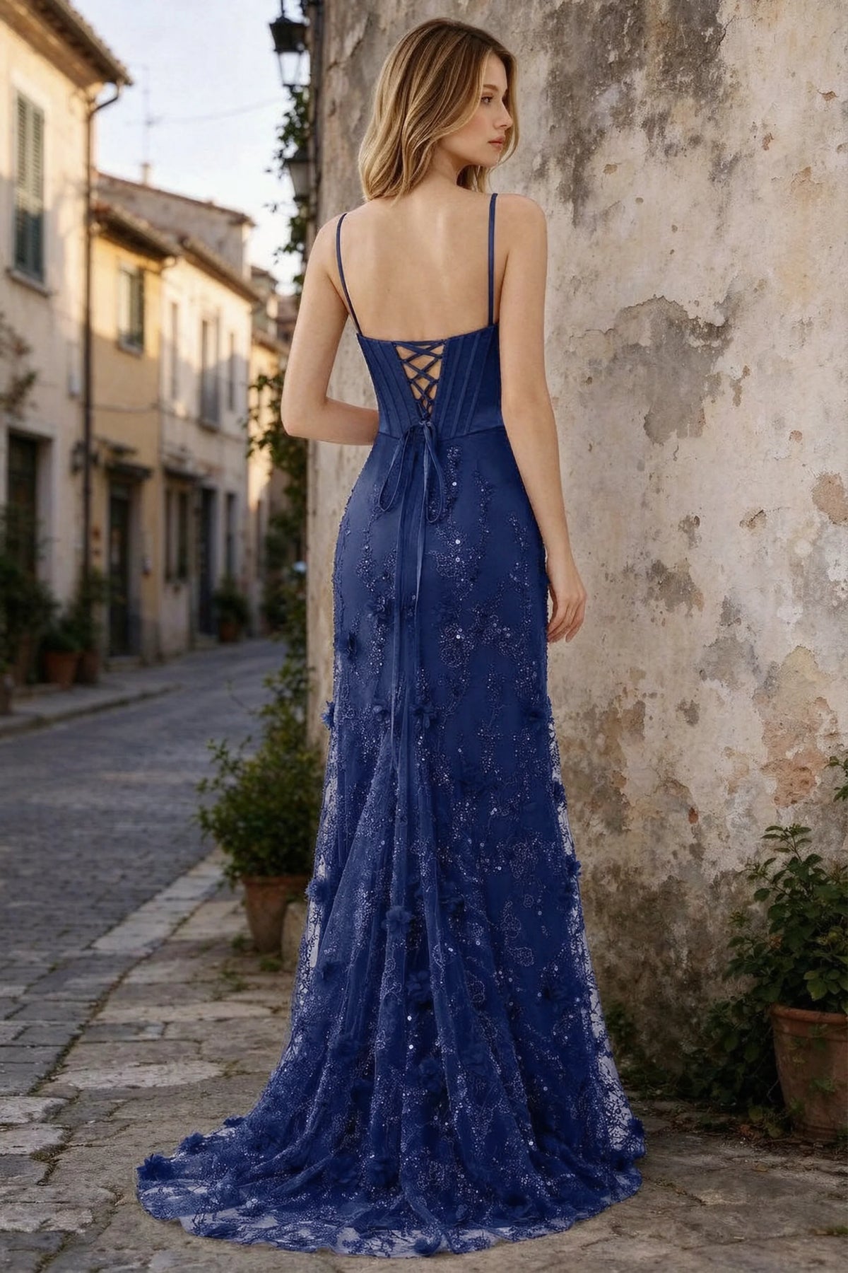 Outdoor rear view of Beth navy maxi dress showing back lacing and the long embellished skirt