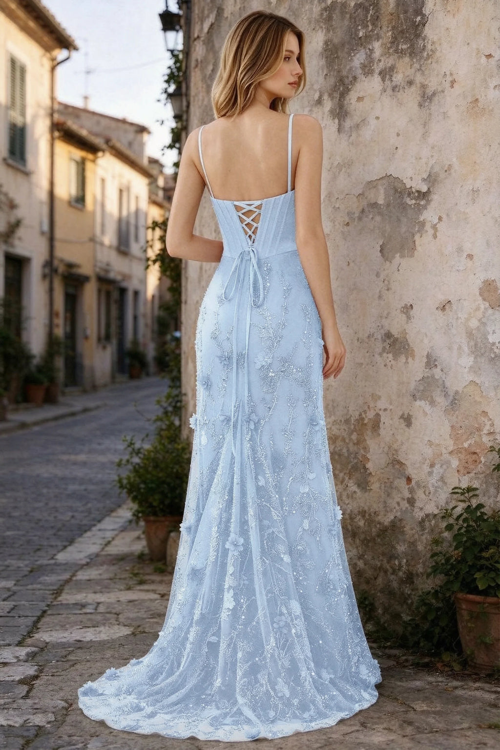Outdoor rear view of Beth sky blue maxi dress showing back lacing and the long embellished skirt
