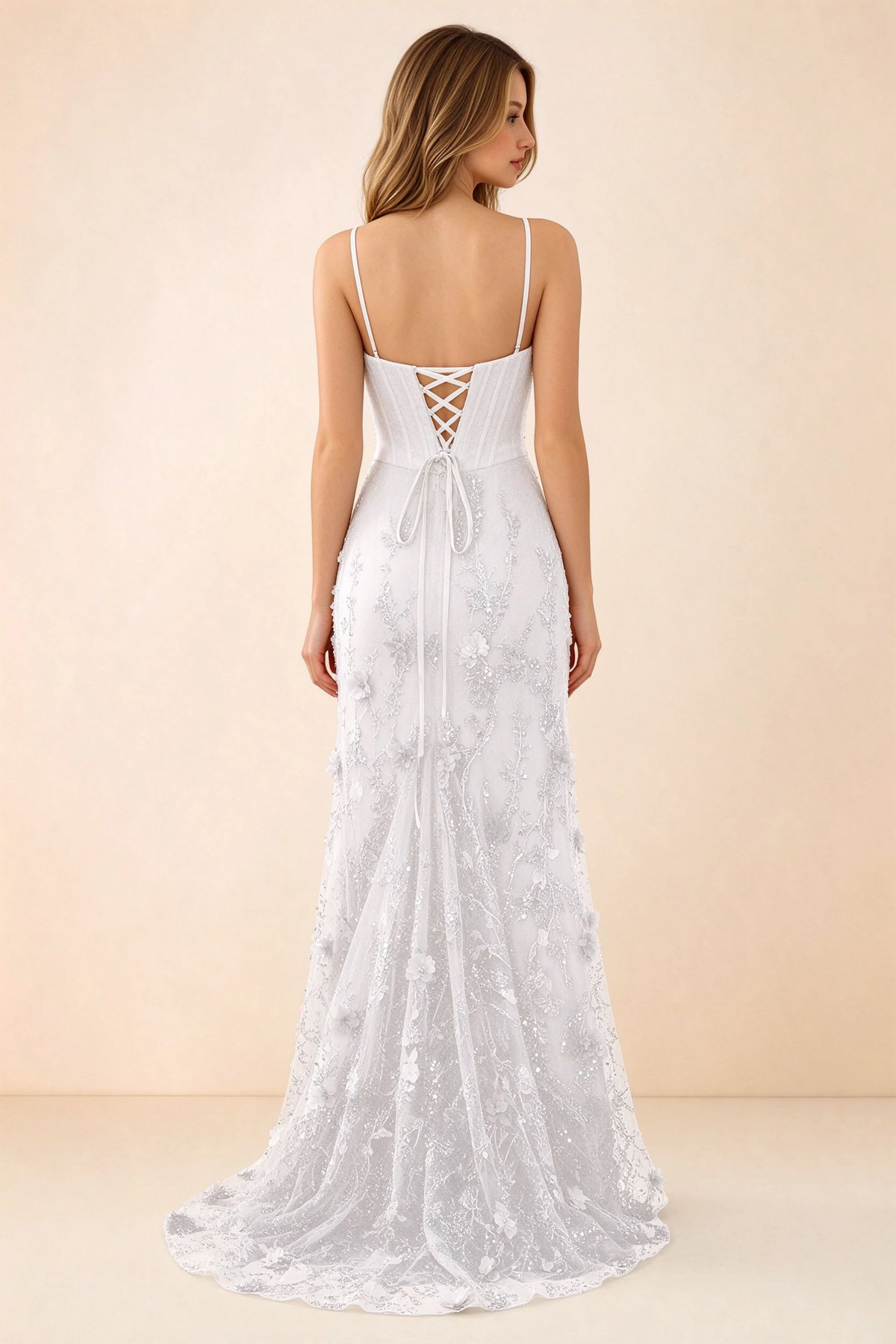 Rear studio view of Beth white dress showing corset back lacing and a trailing floral hem