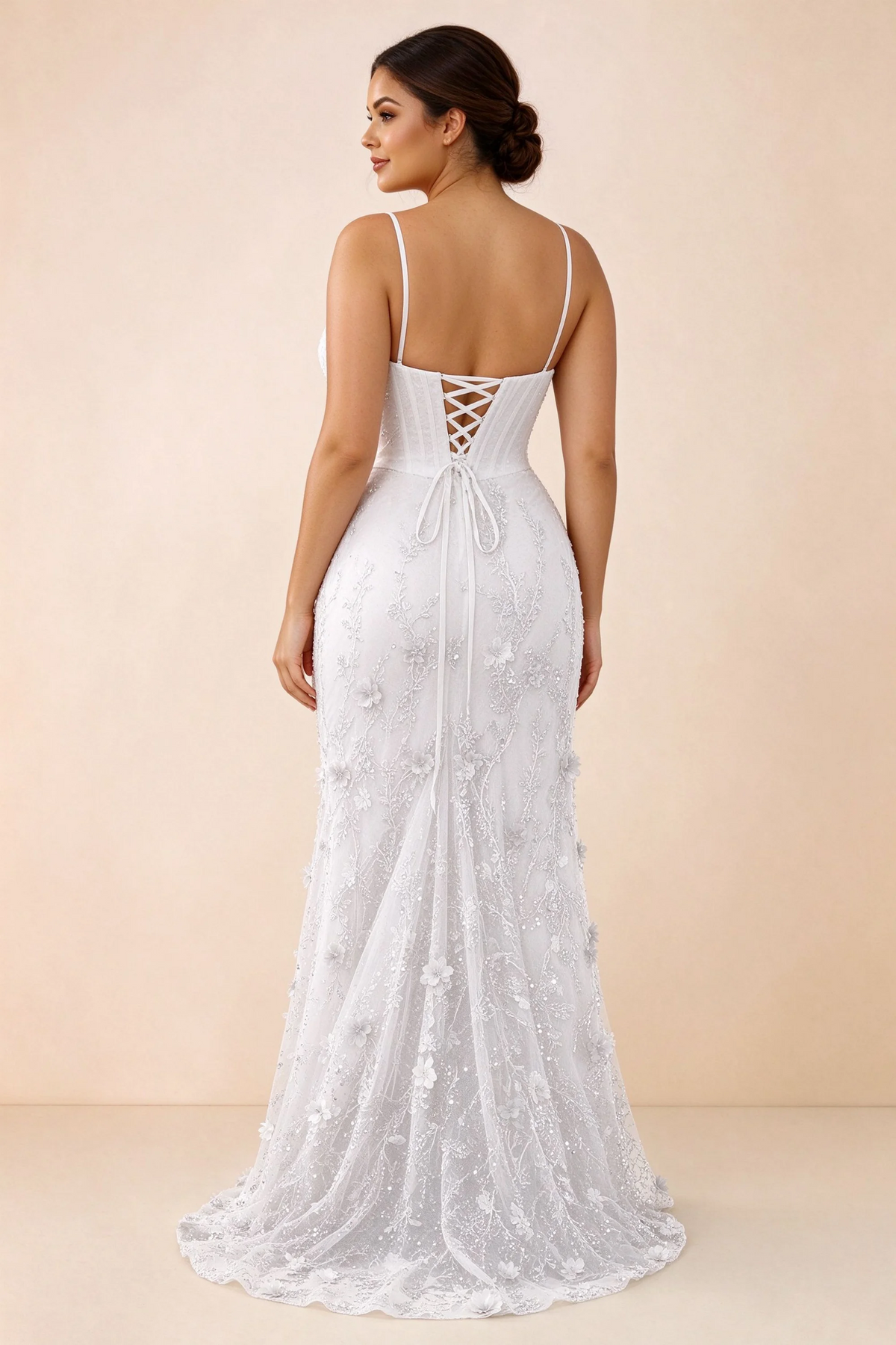 Rear studio view of Beth white corset dress with fine straps, back ties and a trailing hem