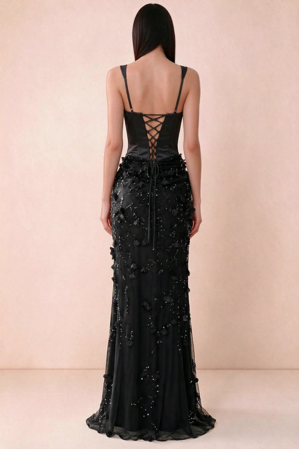Rear studio view of Betsy black dress showing adjustable shoulder straps and corset back lacing