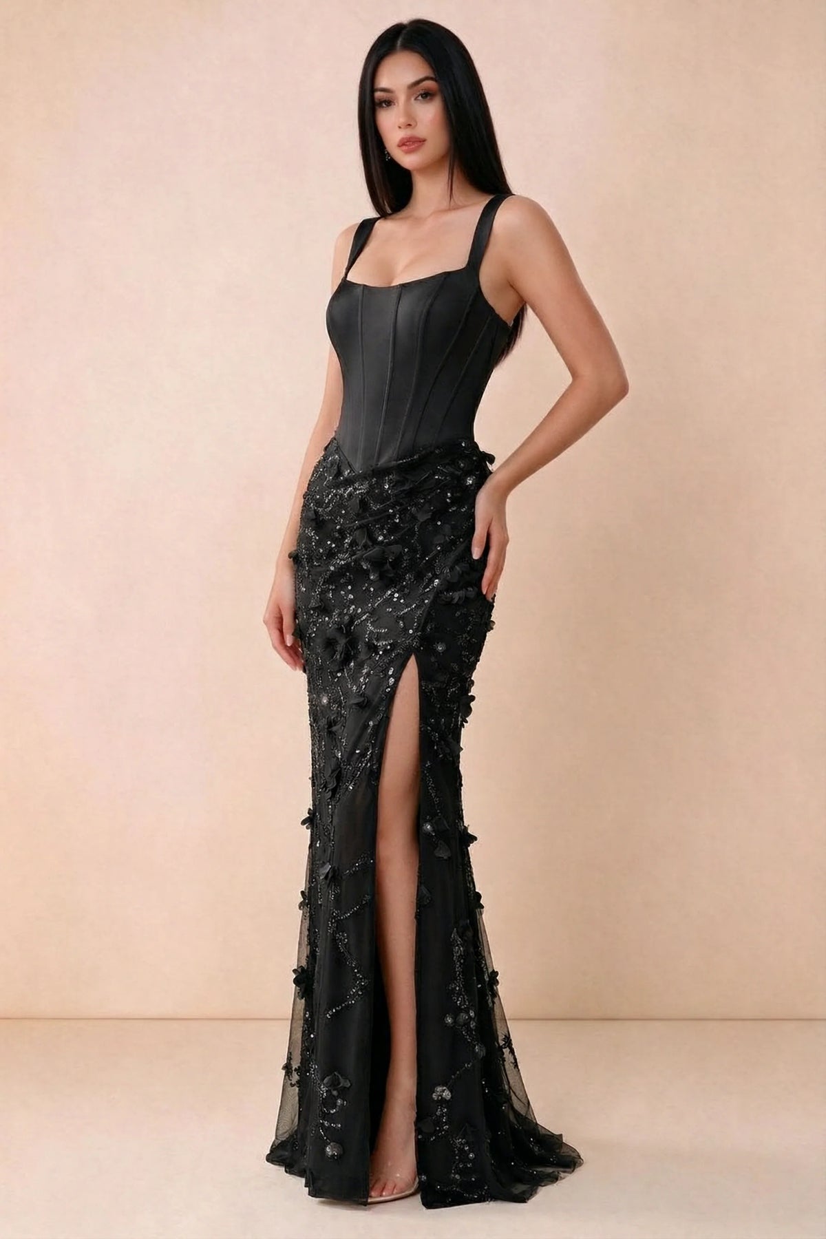 Three-quarter studio view of Betsy black dress showing the gathered hip detail and side slit