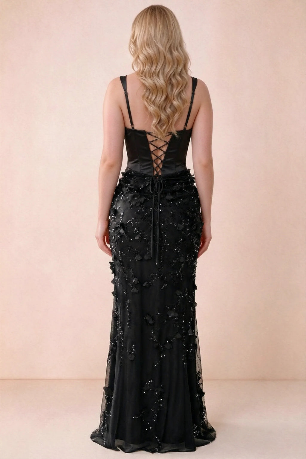 Rear studio view of Betsy black dress showing the broad straps and fitted floral skirt