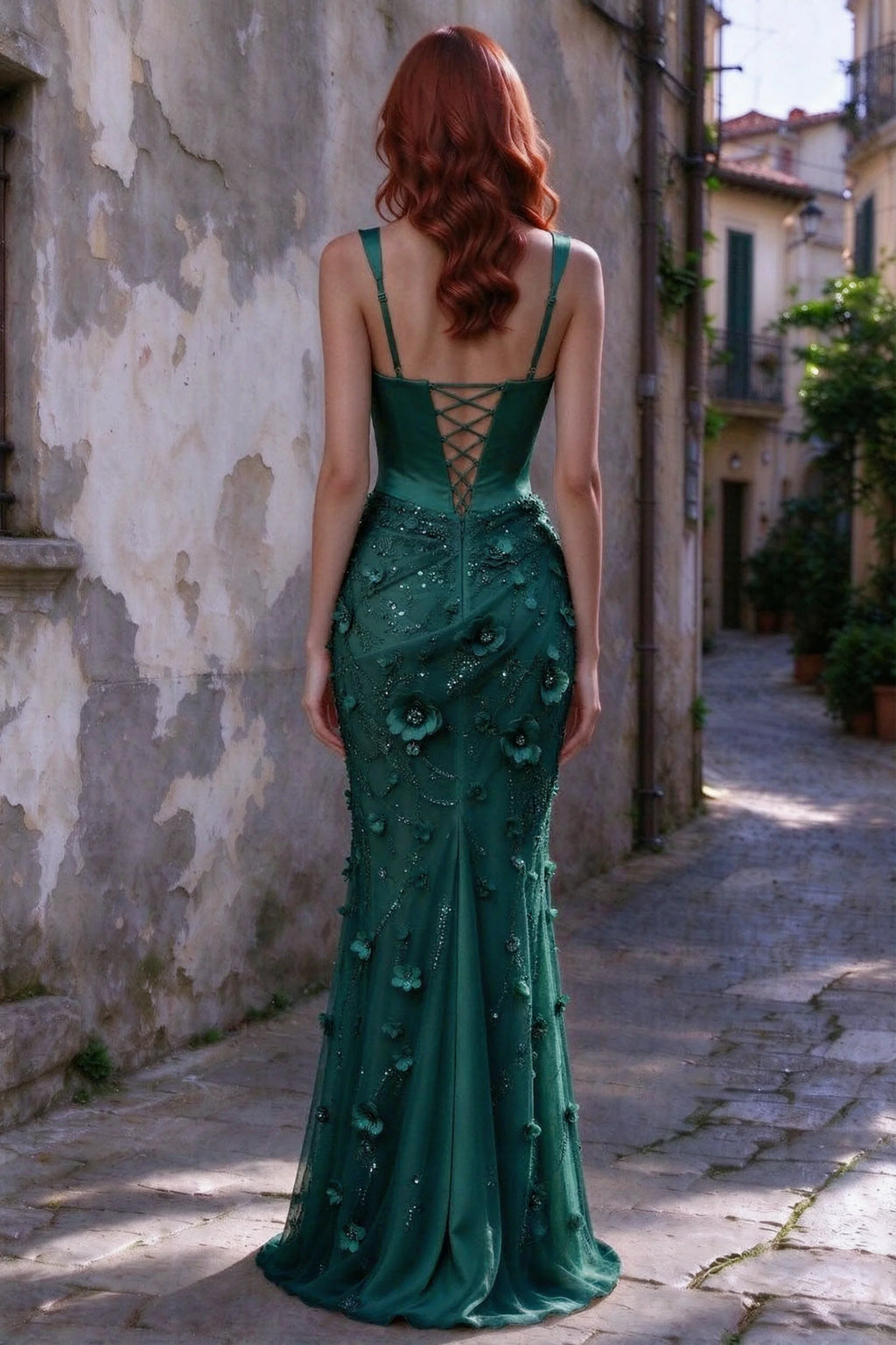 Outdoor rear view of Betsy emerald green maxi dress showing the lace-up bodice and long floral skirt