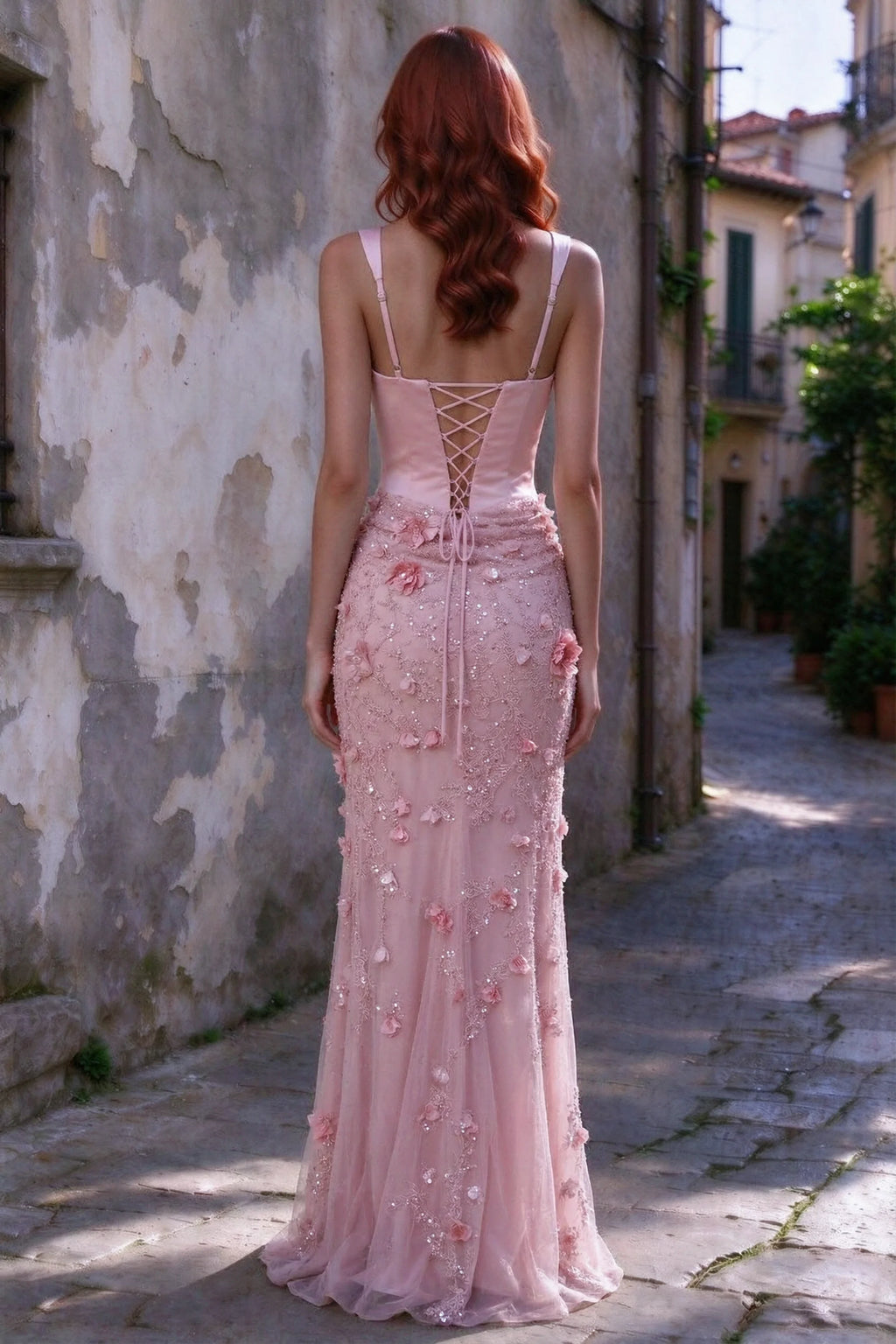 Outdoor rear view of Betsy pink maxi dress showing the lace-up bodice and long floral skirt