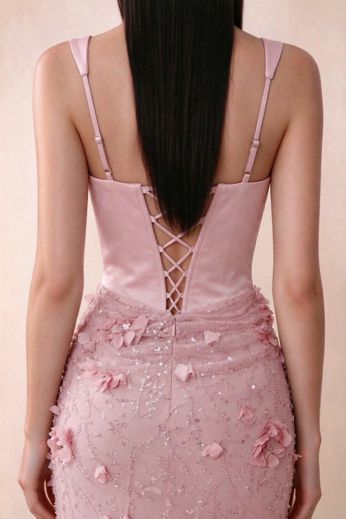 Close-up of Betsy pink adjustable strap sliders and crossed back lacing above the beaded skirt