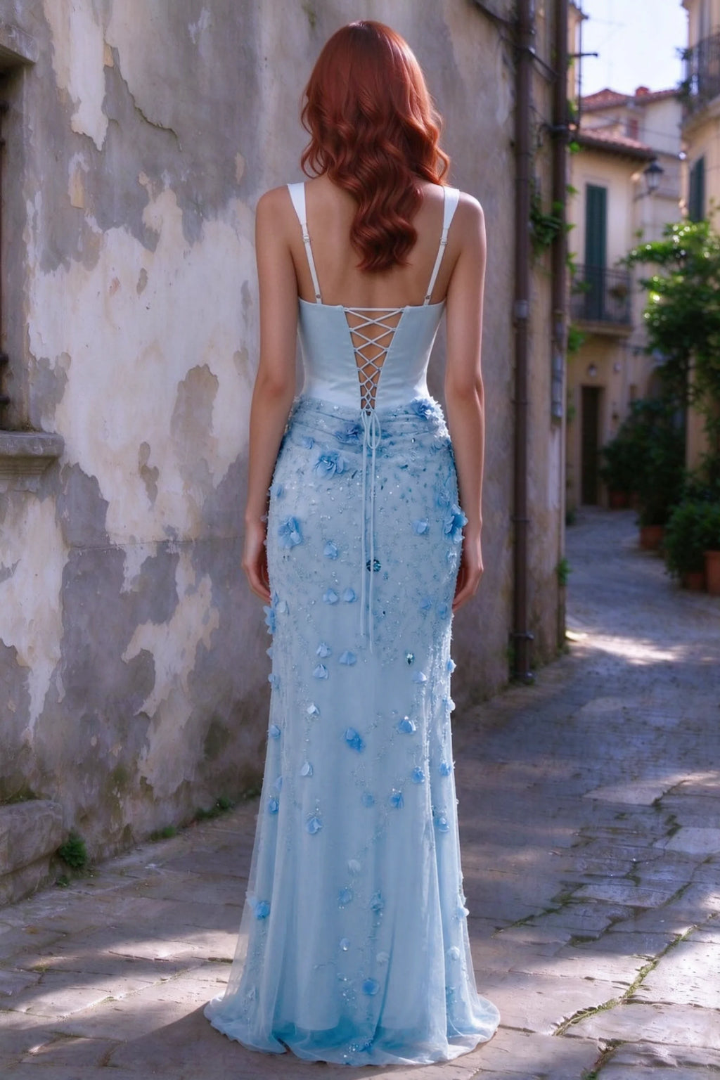 Outdoor rear view of Betsy sky blue maxi dress showing the lace-up bodice and long floral skirt