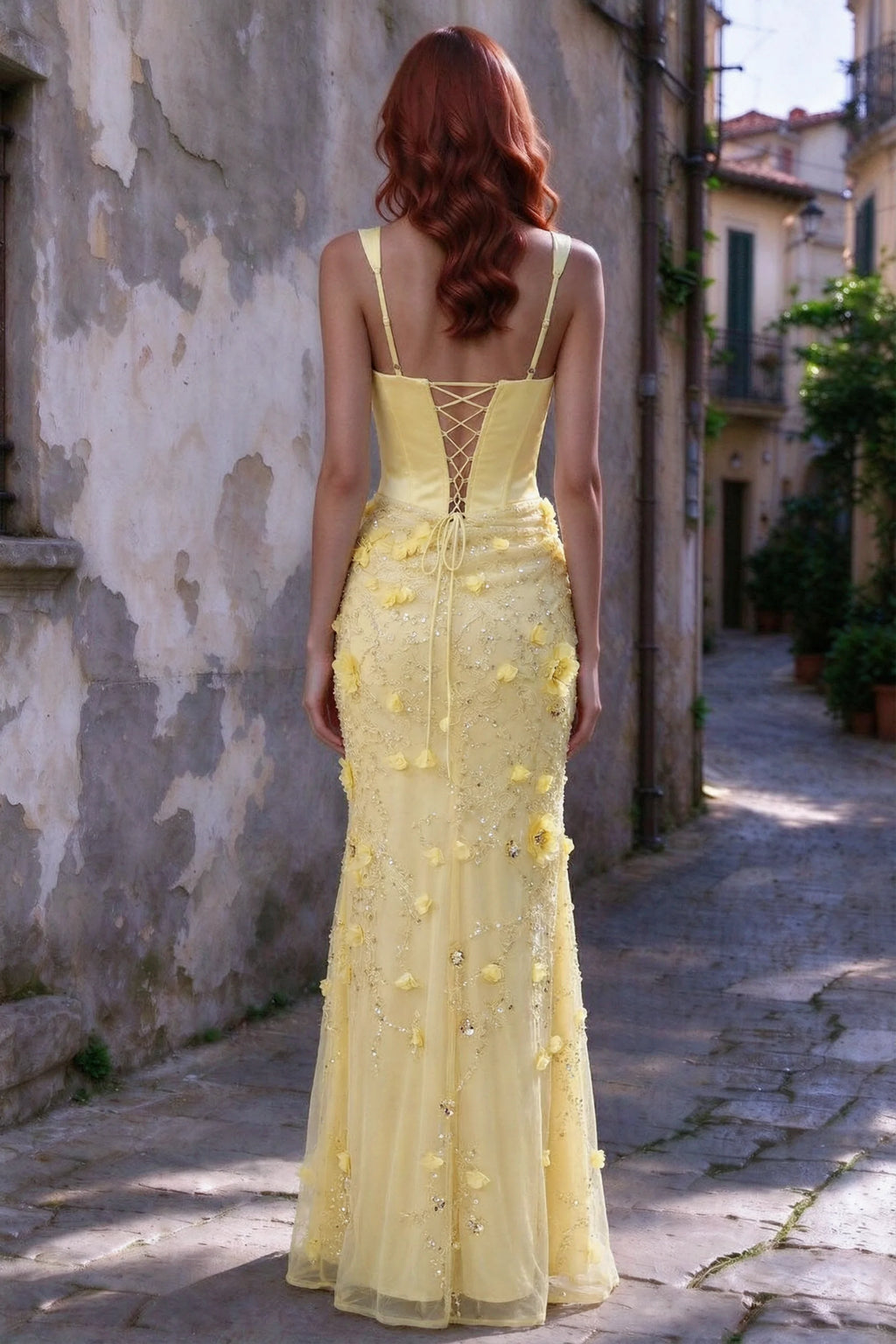 Outdoor rear view of Betsy yellow maxi dress showing the lace-up bodice and long floral skirt