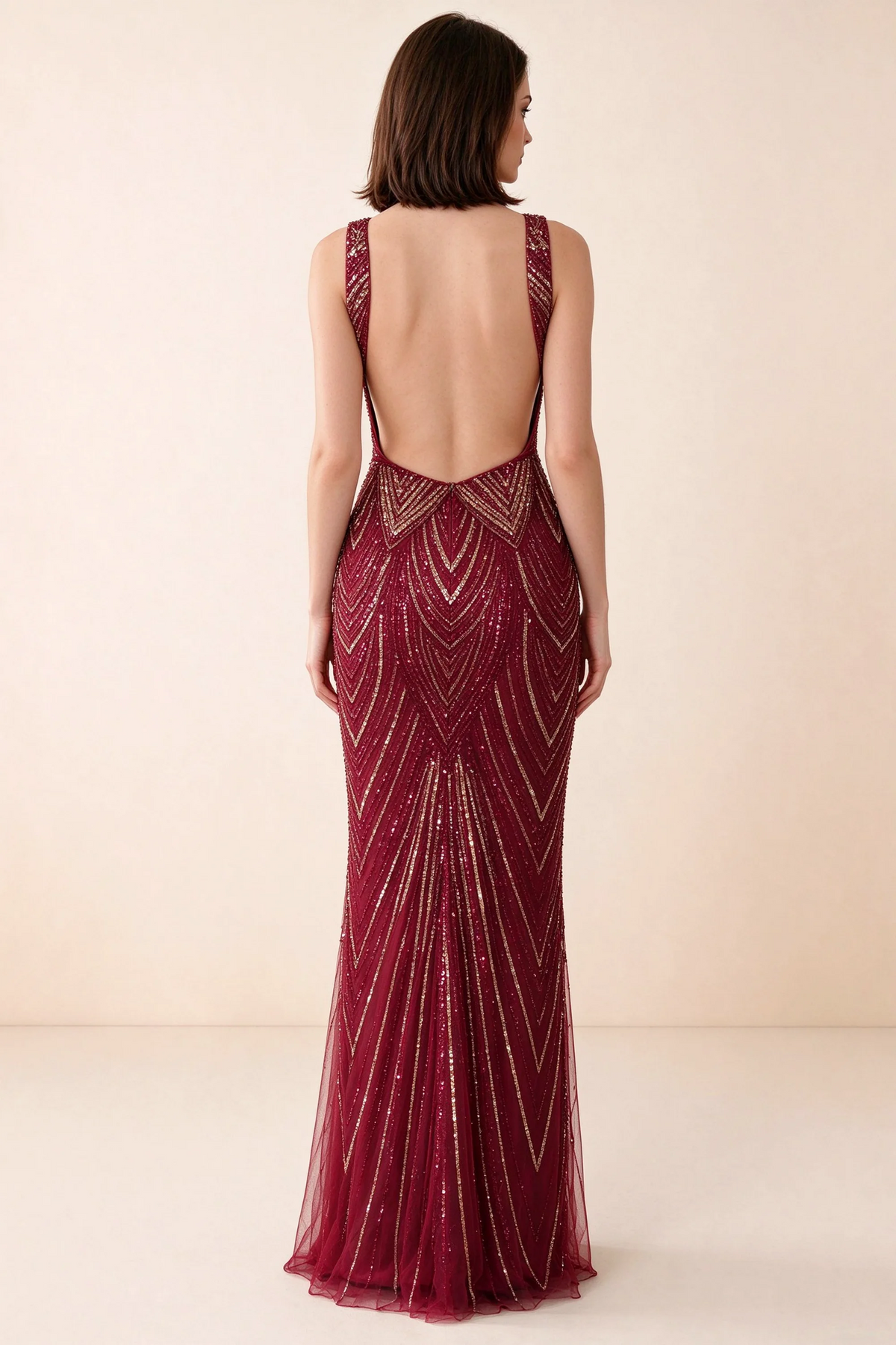Rear studio view of Betty burgundy and gold dress showing wide shoulder straps and a low scooped open back