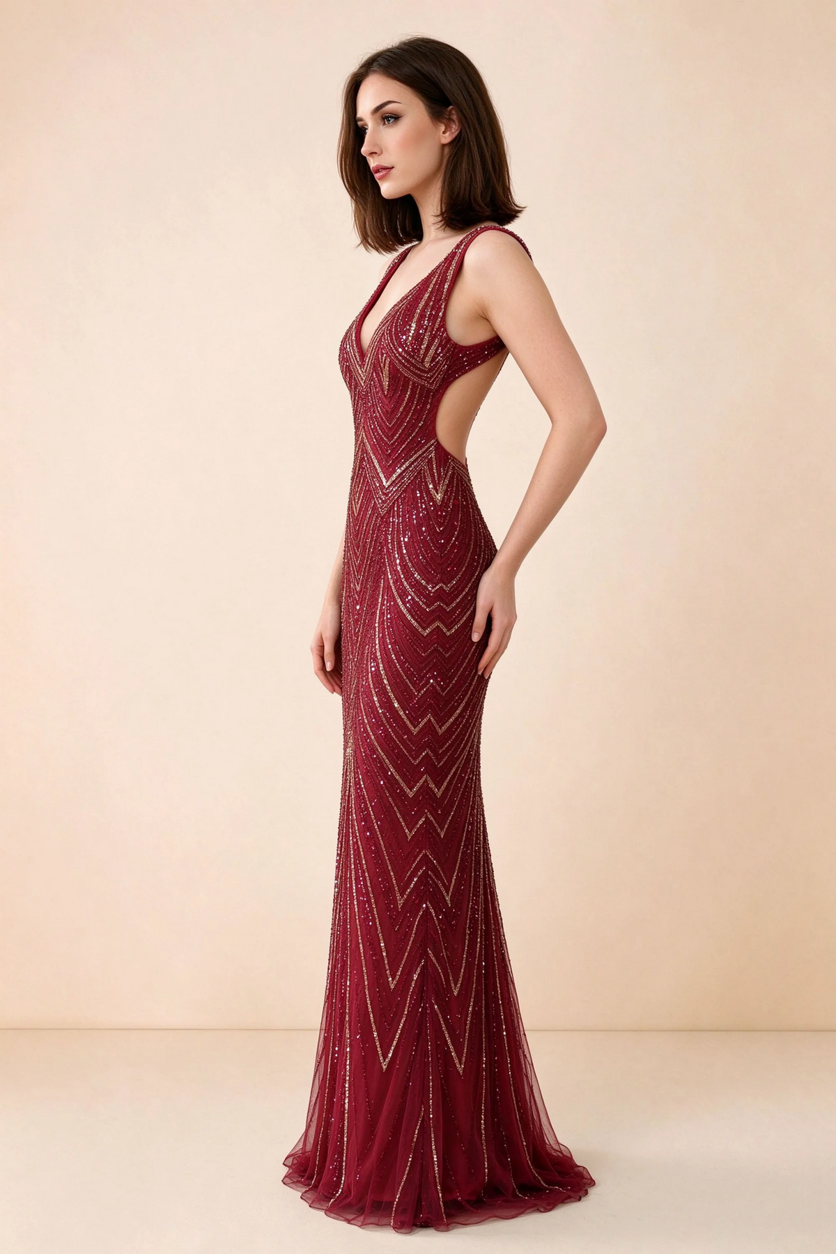 Three-quarter studio view of Betty burgundy and gold dress showing the fitted hips and gently flared hem