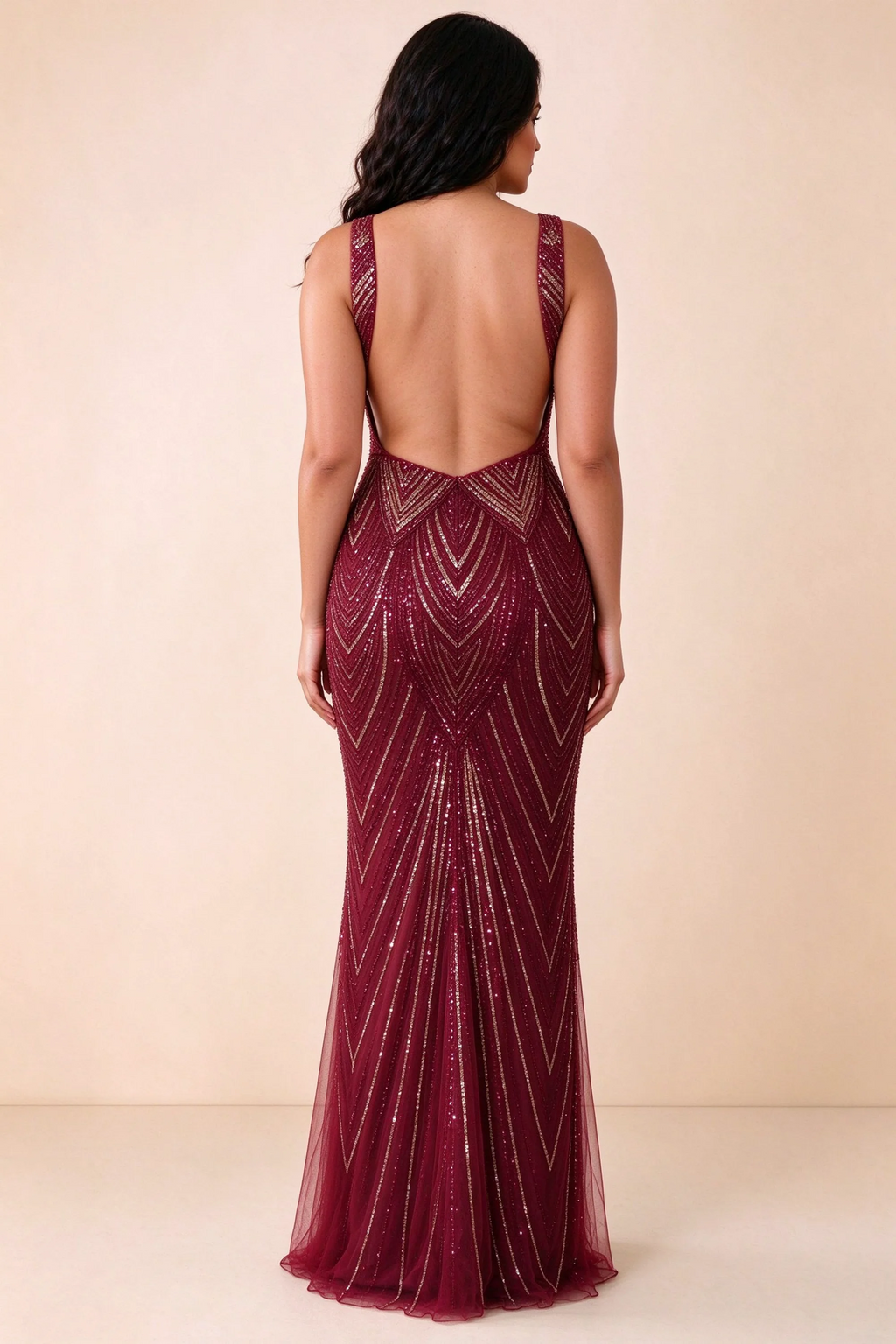 Rear studio view of Betty burgundy and gold dress showing the open back and floor-length silhouette