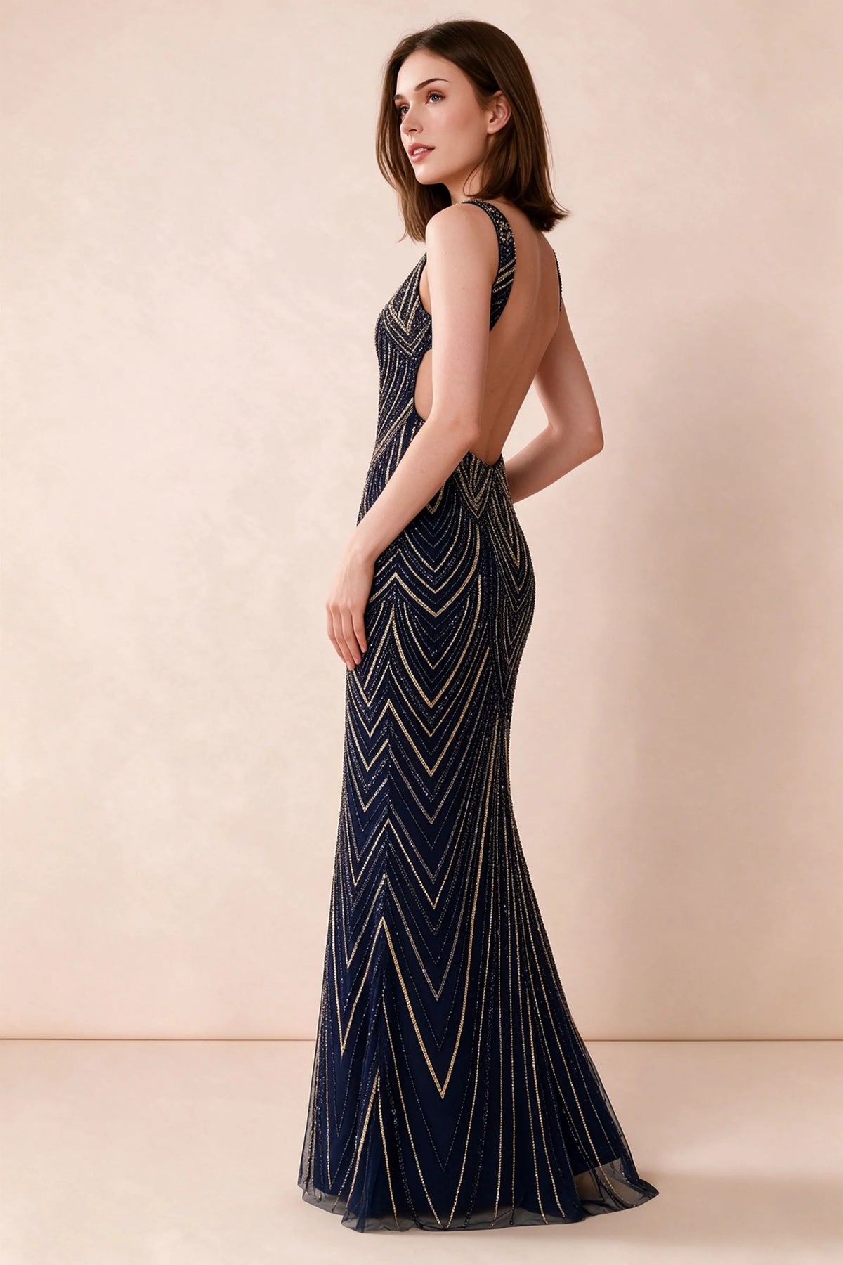 Three-quarter studio view of Betty navy and gold dress showing the fitted hips and gently flared hem