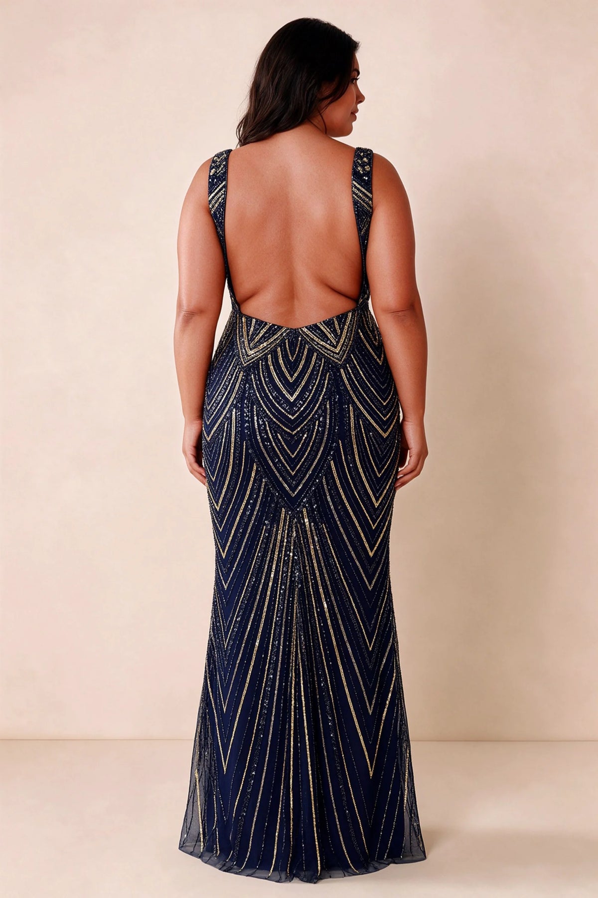 Rear studio view of Betty navy and gold dress showing the open back and floor-length silhouette