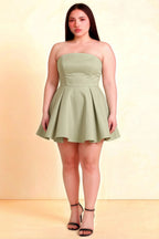 Plus Size Model Wearing LVLVS Sage Green Satin Beverly Dress Strapless Open Back Mini Skater Dress for Office Work Party