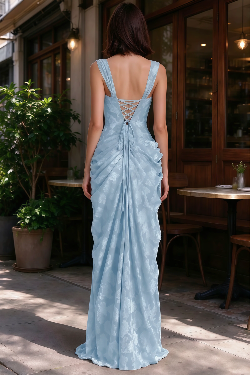 Outdoor rear view of Blair powder blue jacquard dress showing the lace-up back and gathered skirt