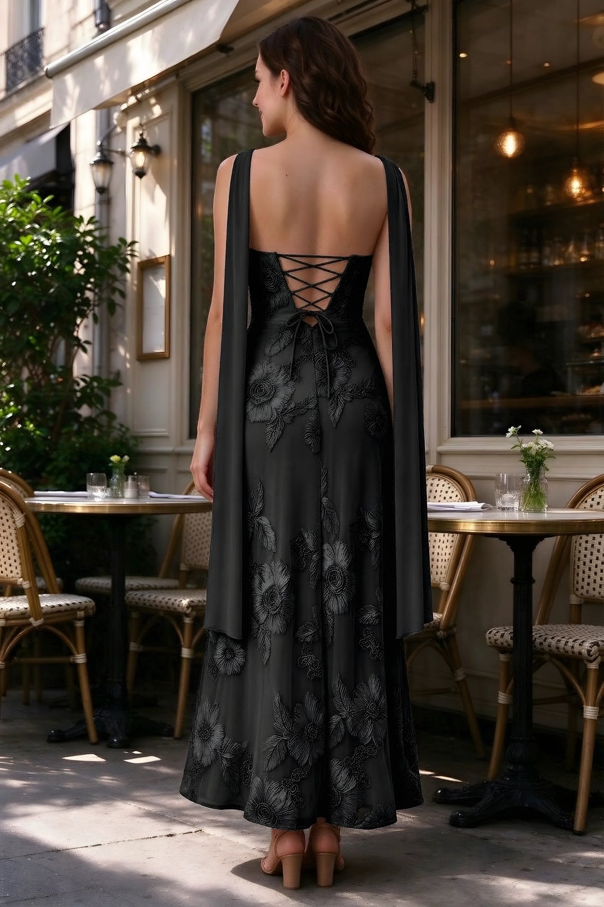 Outdoor rear view of Carey black dress showing the lace-up back and long scarf ends