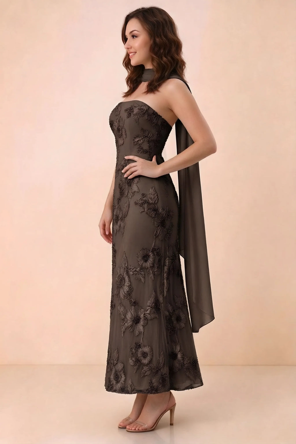 Three-quarter studio view of Carey chocolate strapless dress showing the fitted waist and floral appliques