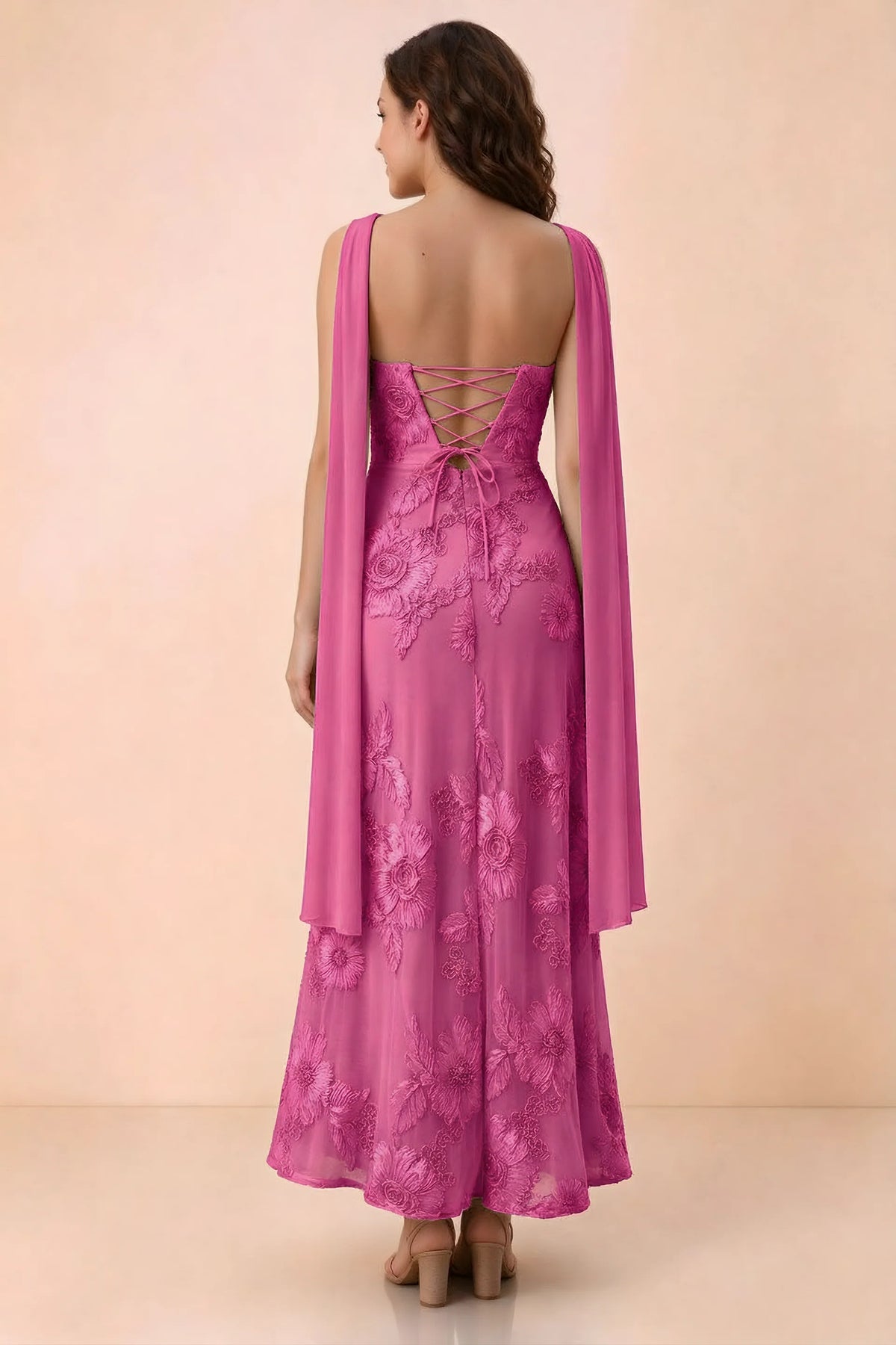 Rear studio view of Carey fuchsia dress showing crossed back lacing and scarf ends draped over the shoulders