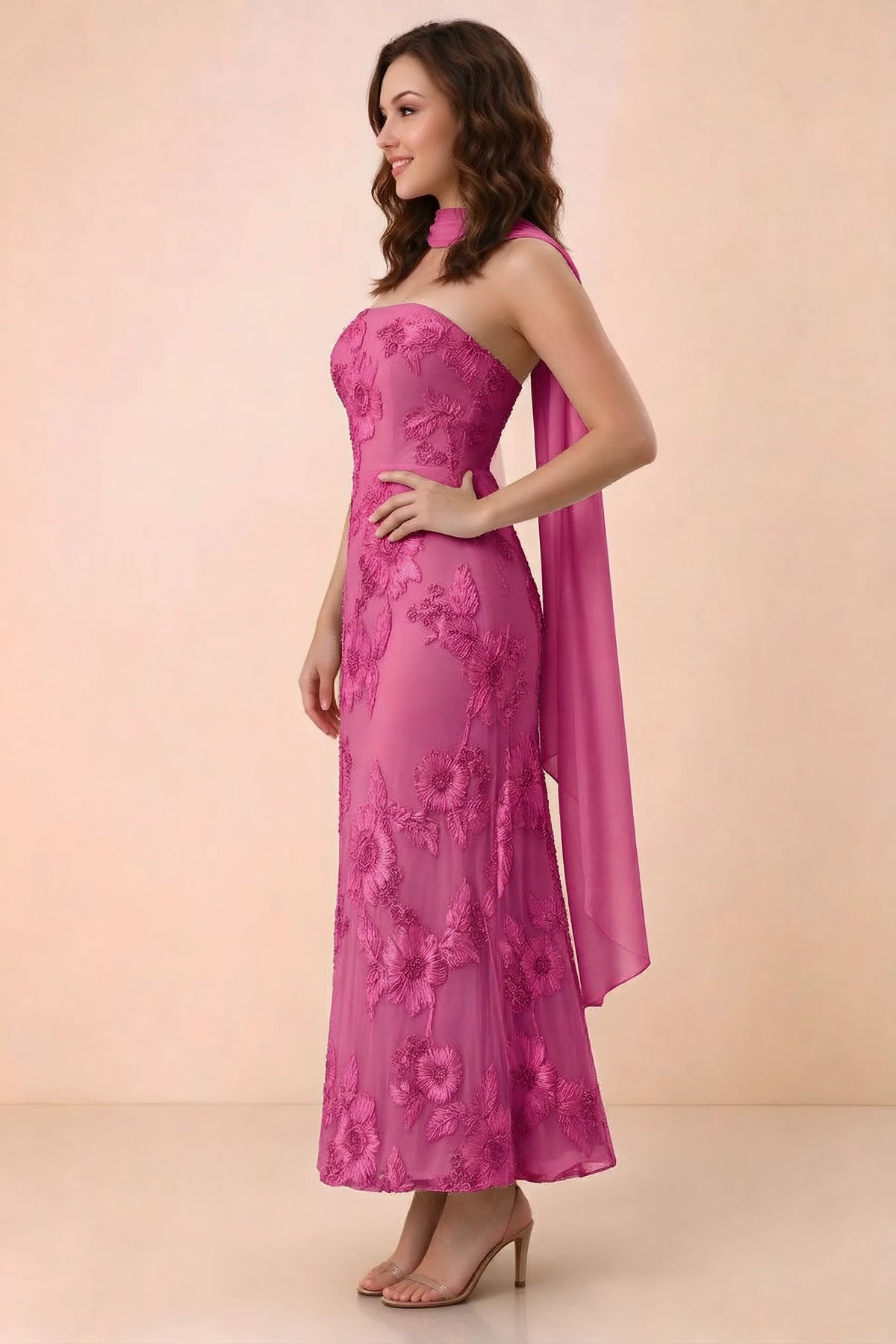 Three-quarter studio view of Carey fuchsia strapless dress showing the fitted waist and floral appliques