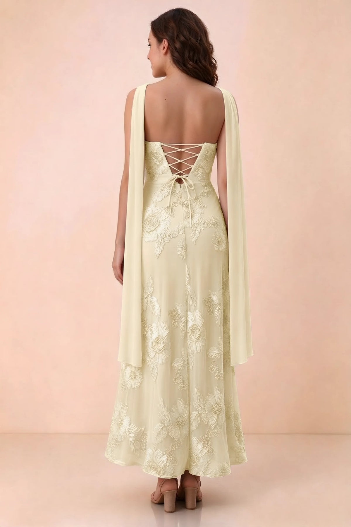 Rear studio view of Carey lemon dress showing crossed back lacing and scarf ends draped over the shoulders