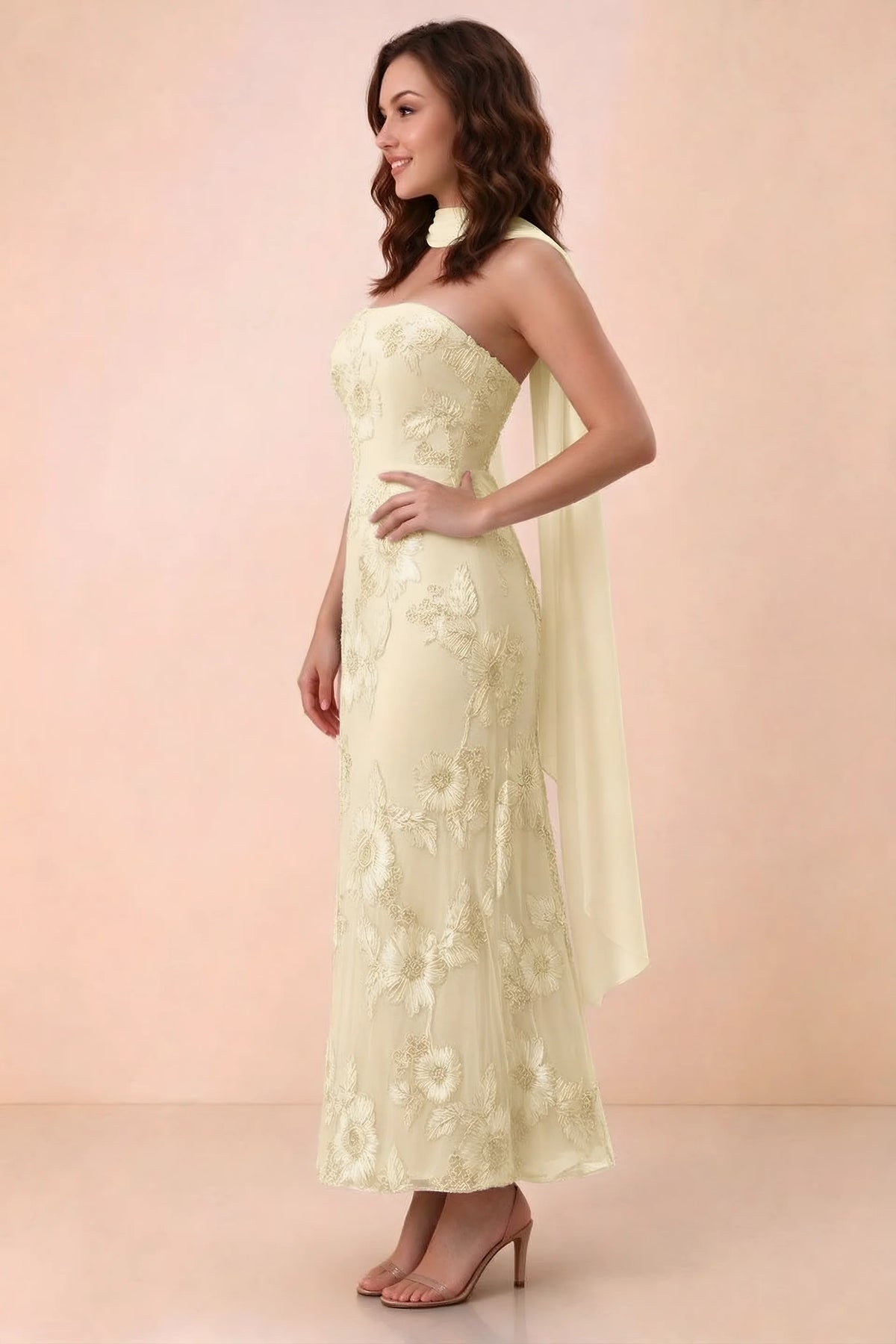Three-quarter studio view of Carey lemon strapless dress showing the fitted waist and floral appliques