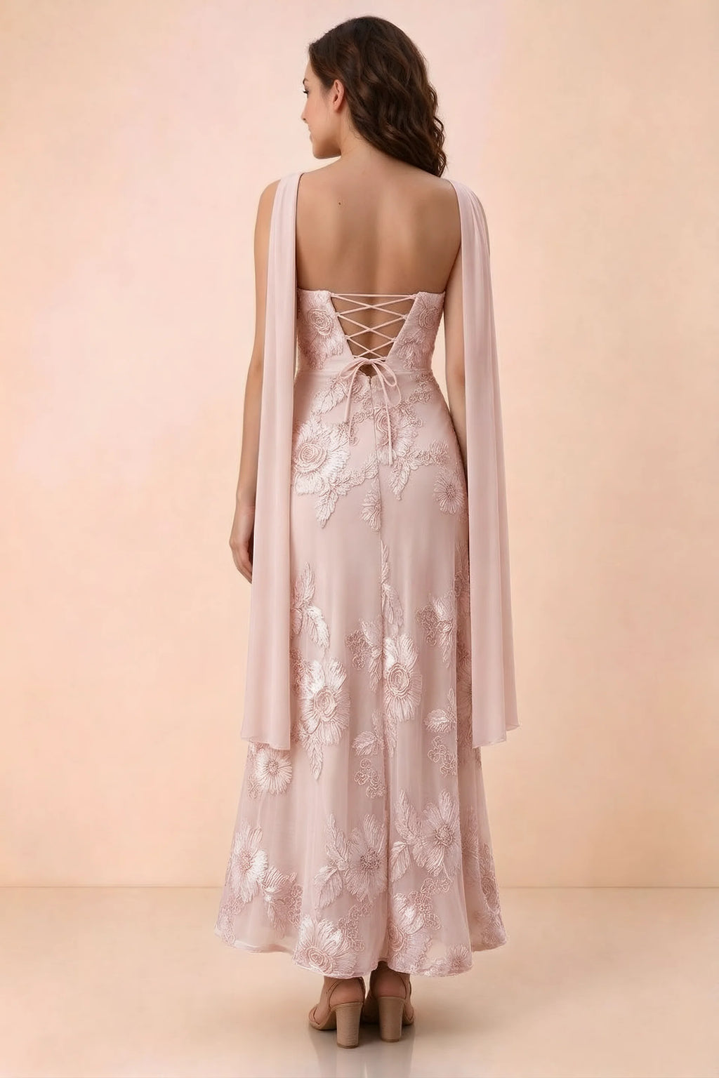 Rear studio view of Carey light pink dress showing crossed back lacing and scarf ends draped over the shoulders