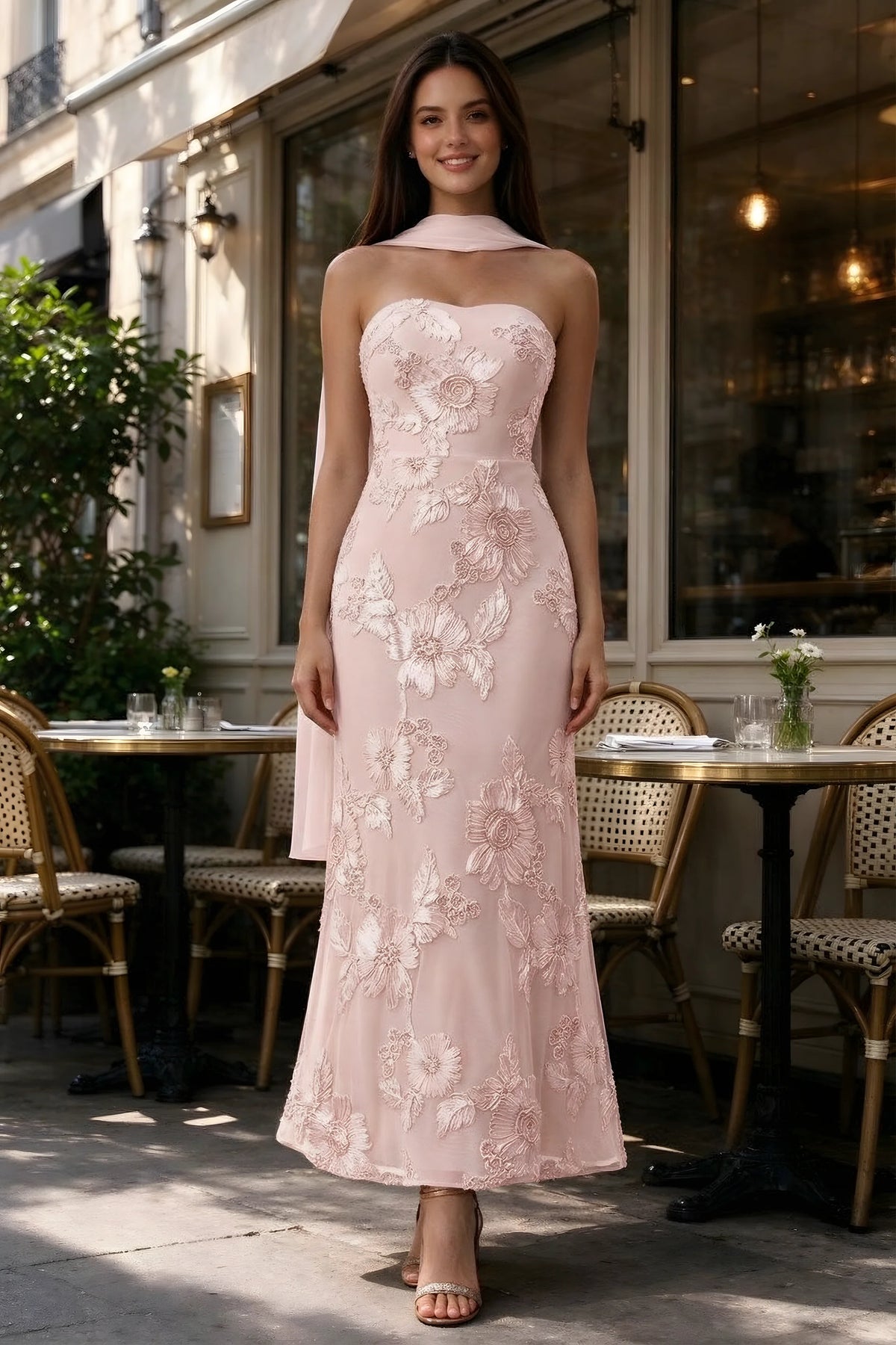 Outdoor front view of Carey light pink floral dress and matching scarf outside a cafe