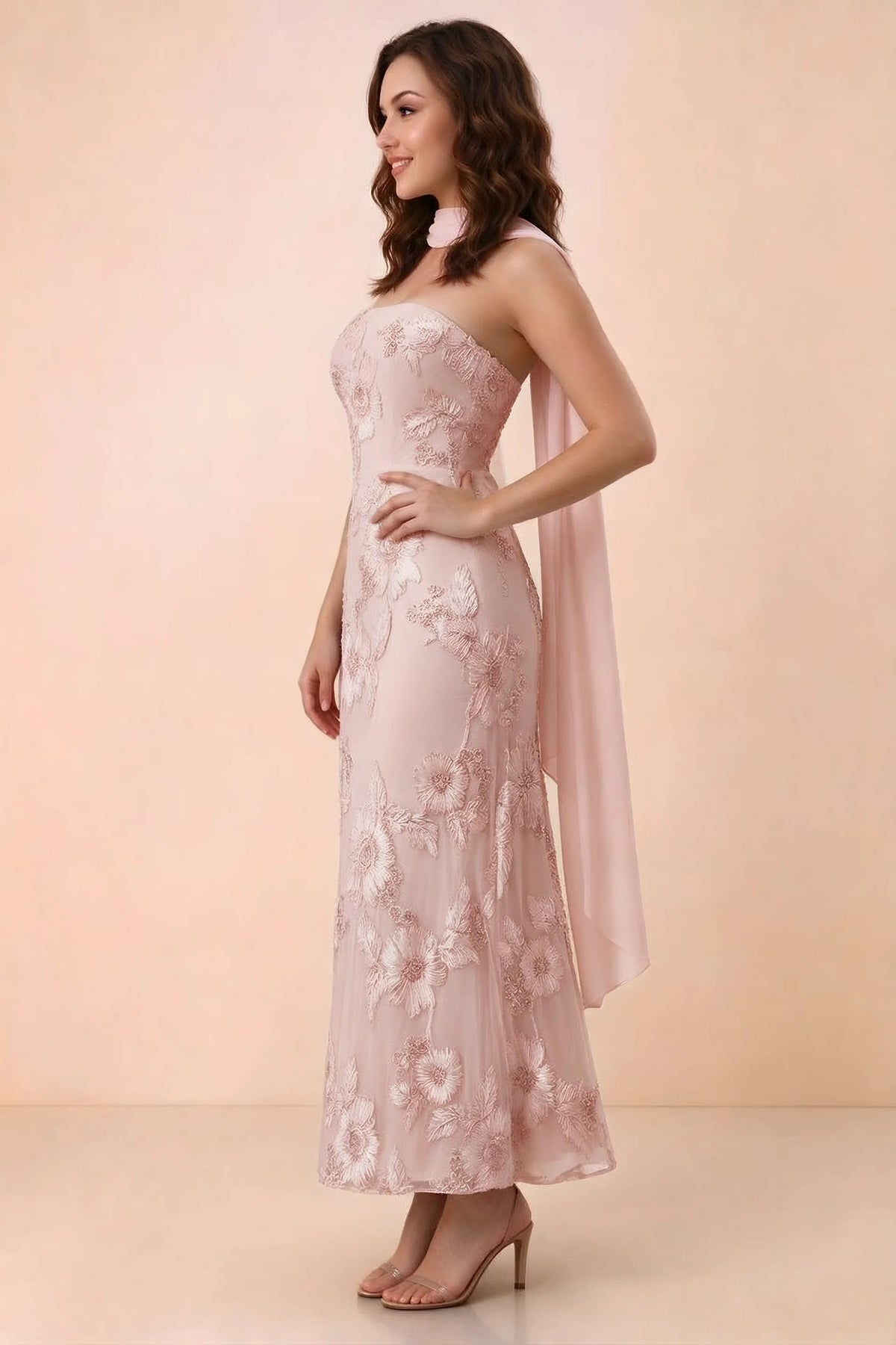 Three-quarter studio view of Carey light pink strapless dress showing the fitted waist and floral appliques